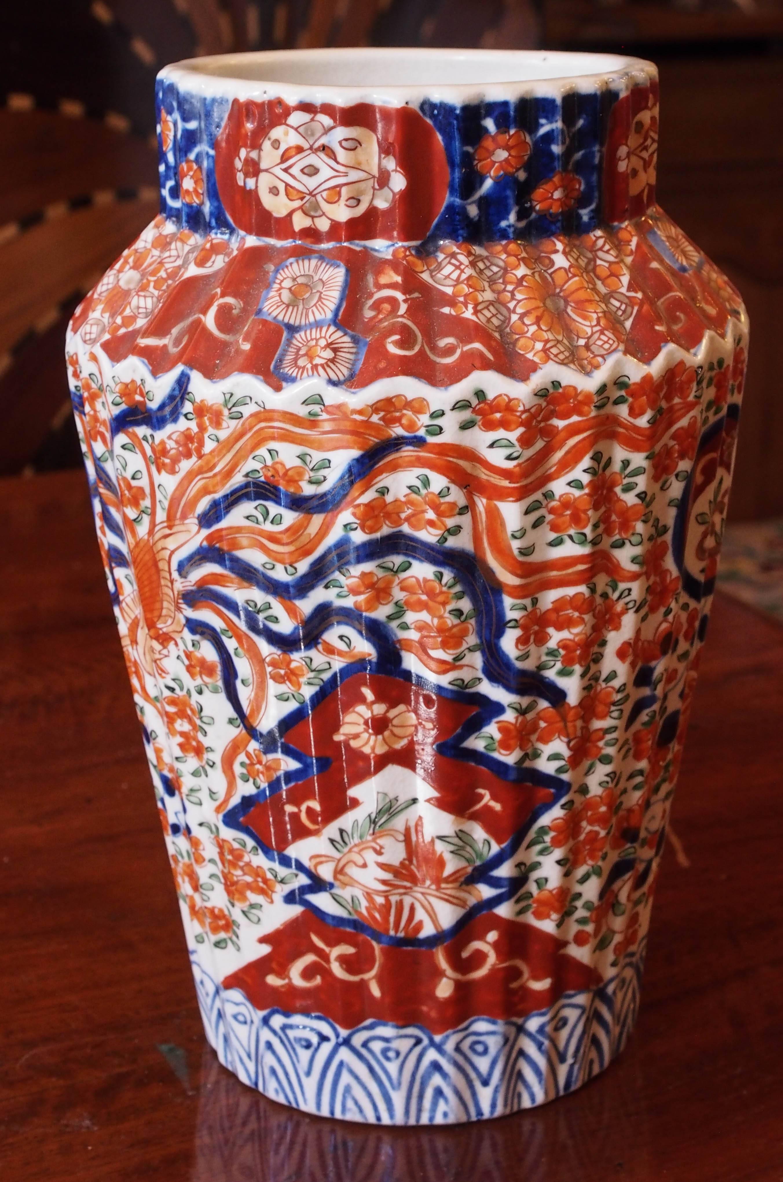 Pair of turn of the century Imari vases wit wide mouths and canted ribbed sides.
       