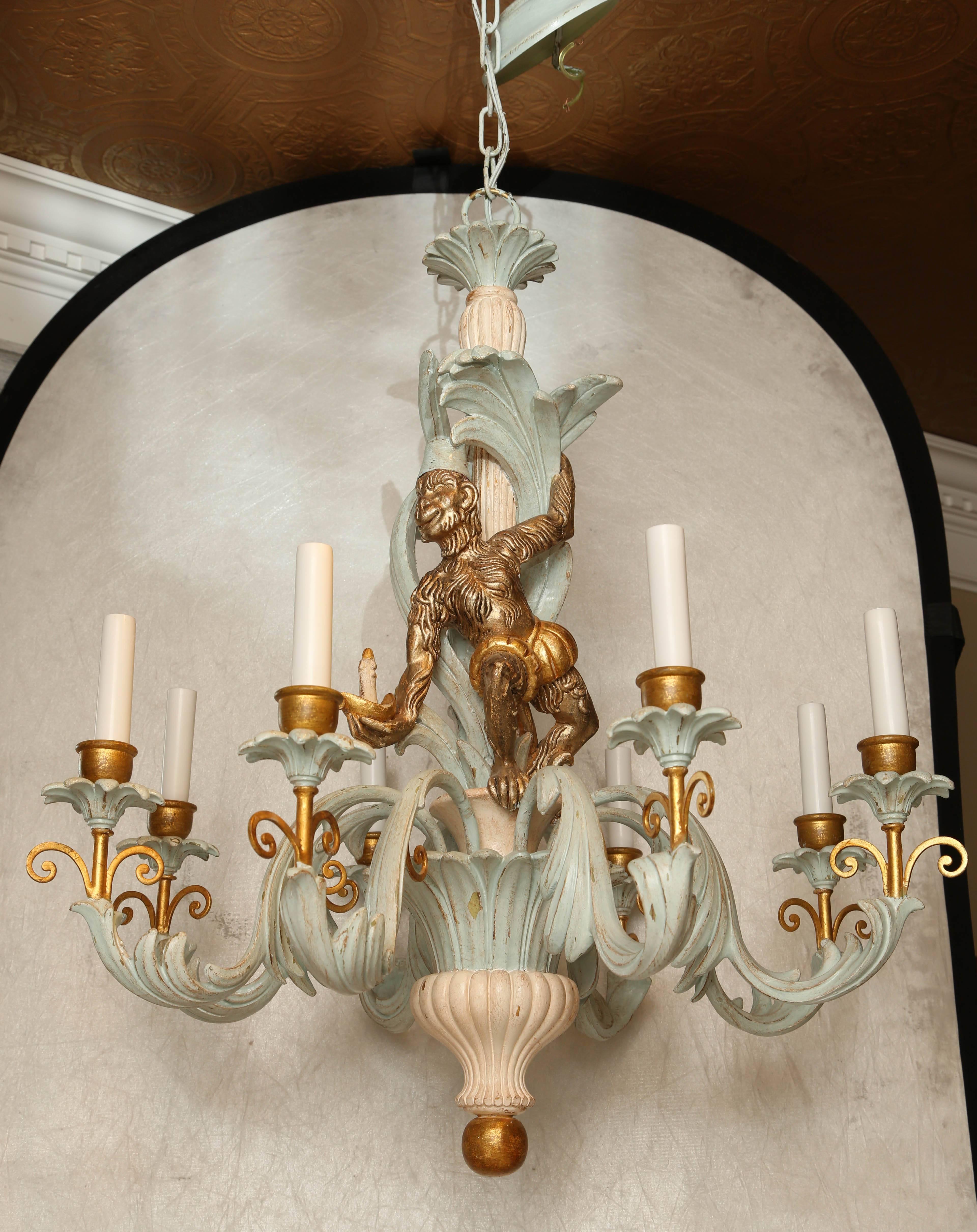 Chandelier, of painted and parcel-gilt, its foliate centre-column, carved with a monkey, eight, exaggerated, S-scroll candle arms with leafy detail, ending in iron scrolls and matching bobeches.

Stock ID: D9434