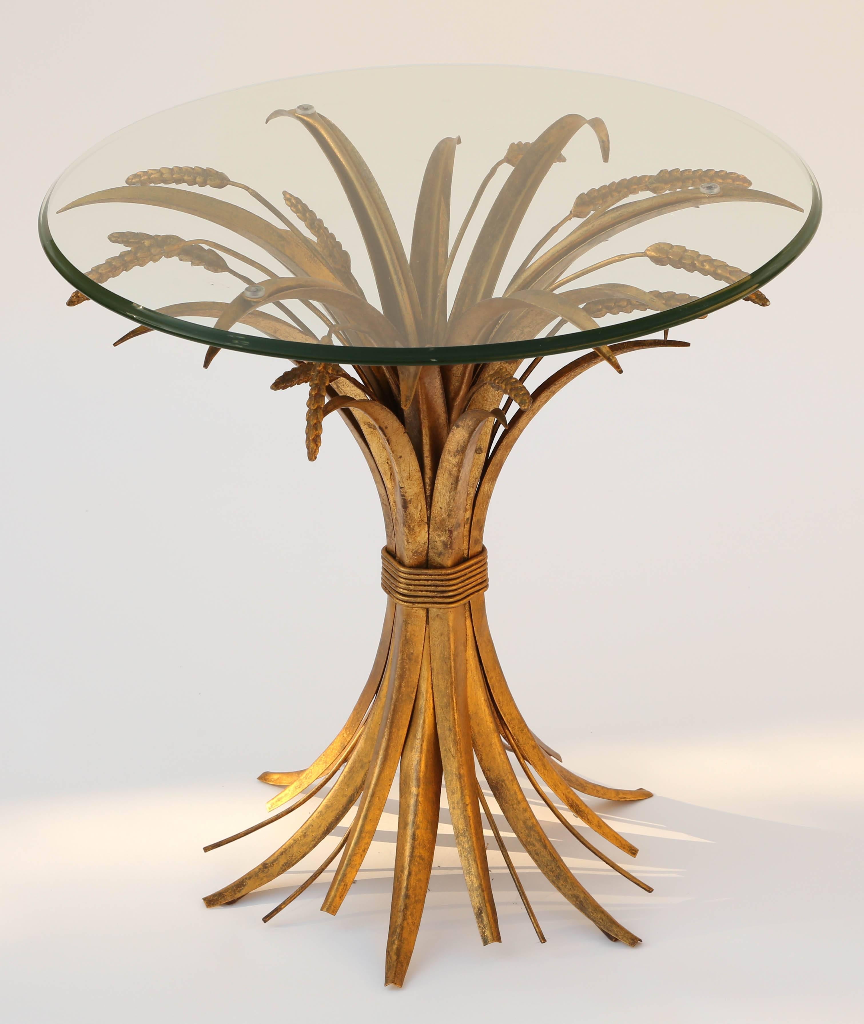 Gilded iron accent table, having a round top of glass, on the "sheaf of wheat" base made famous by Coco Chanel.

Stock ID: D9442