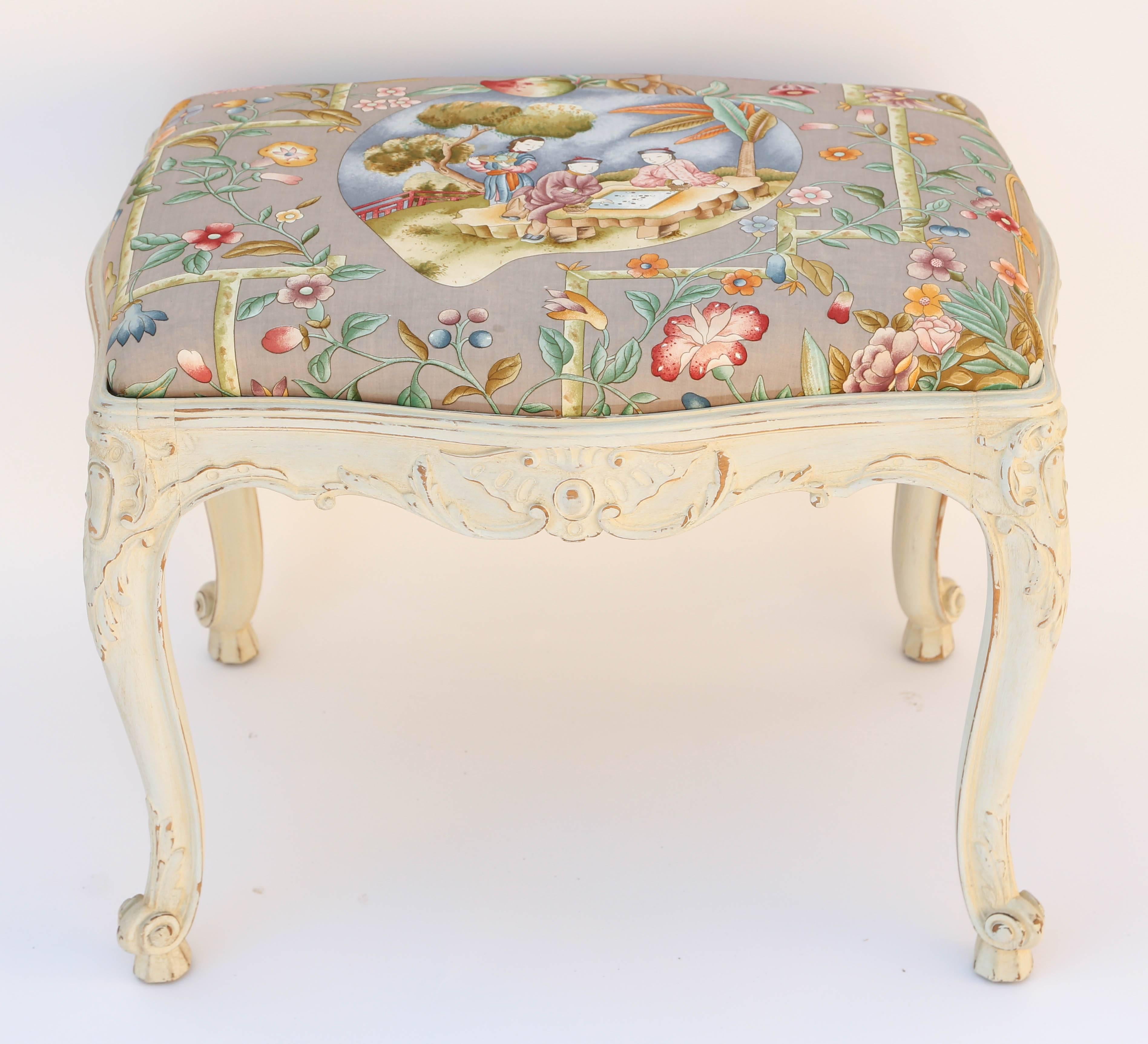 Bench, of painted walnut, having drop-in seat upholstered in exotic chinoiserie print fabric, on frame with serpentine apron carved with scrolls and centered with patera, raised on cabriole legs with scroll toes.

Stock ID: D1458