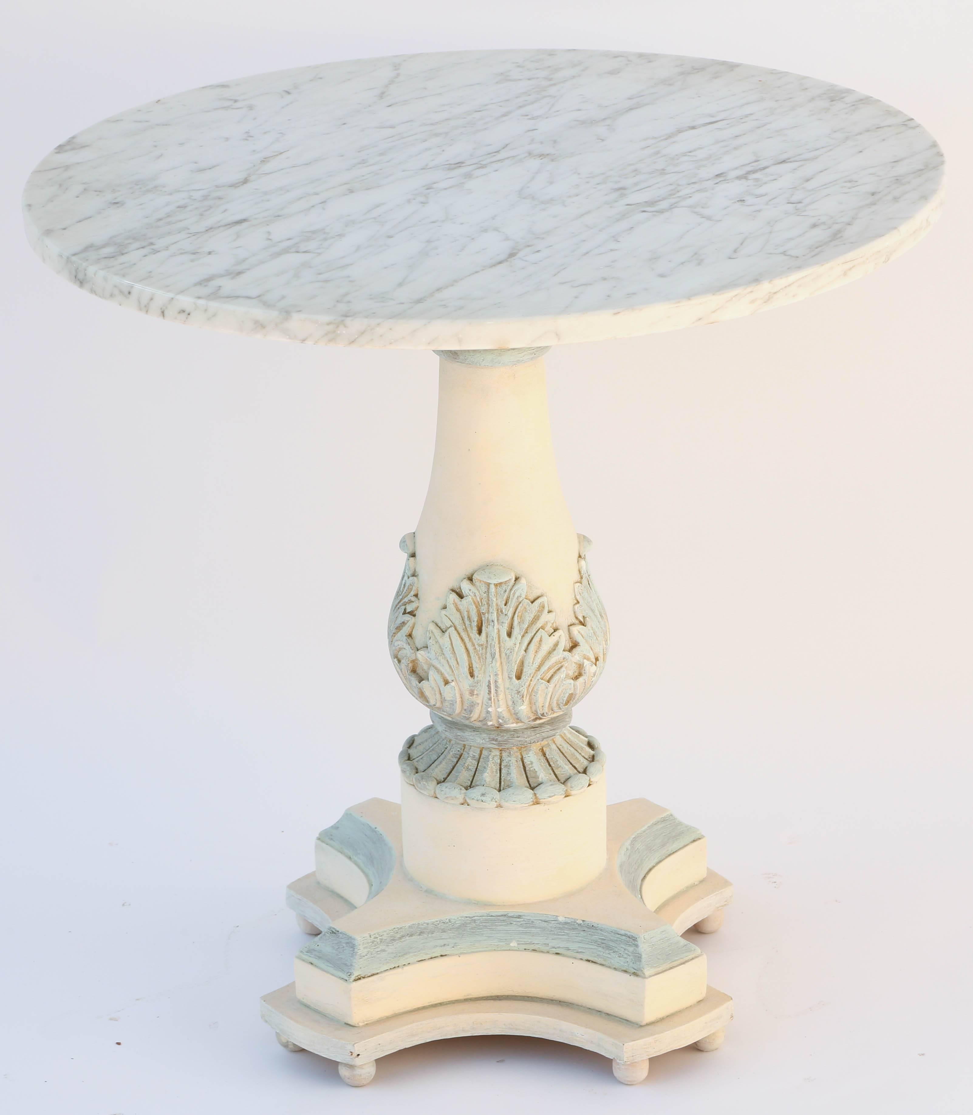 Accent table, having a round top of Carrara marble, on painted pedestal base, in balustrade form with acanthus accents, on square graduated base with concave sides.

Stock ID: D5994