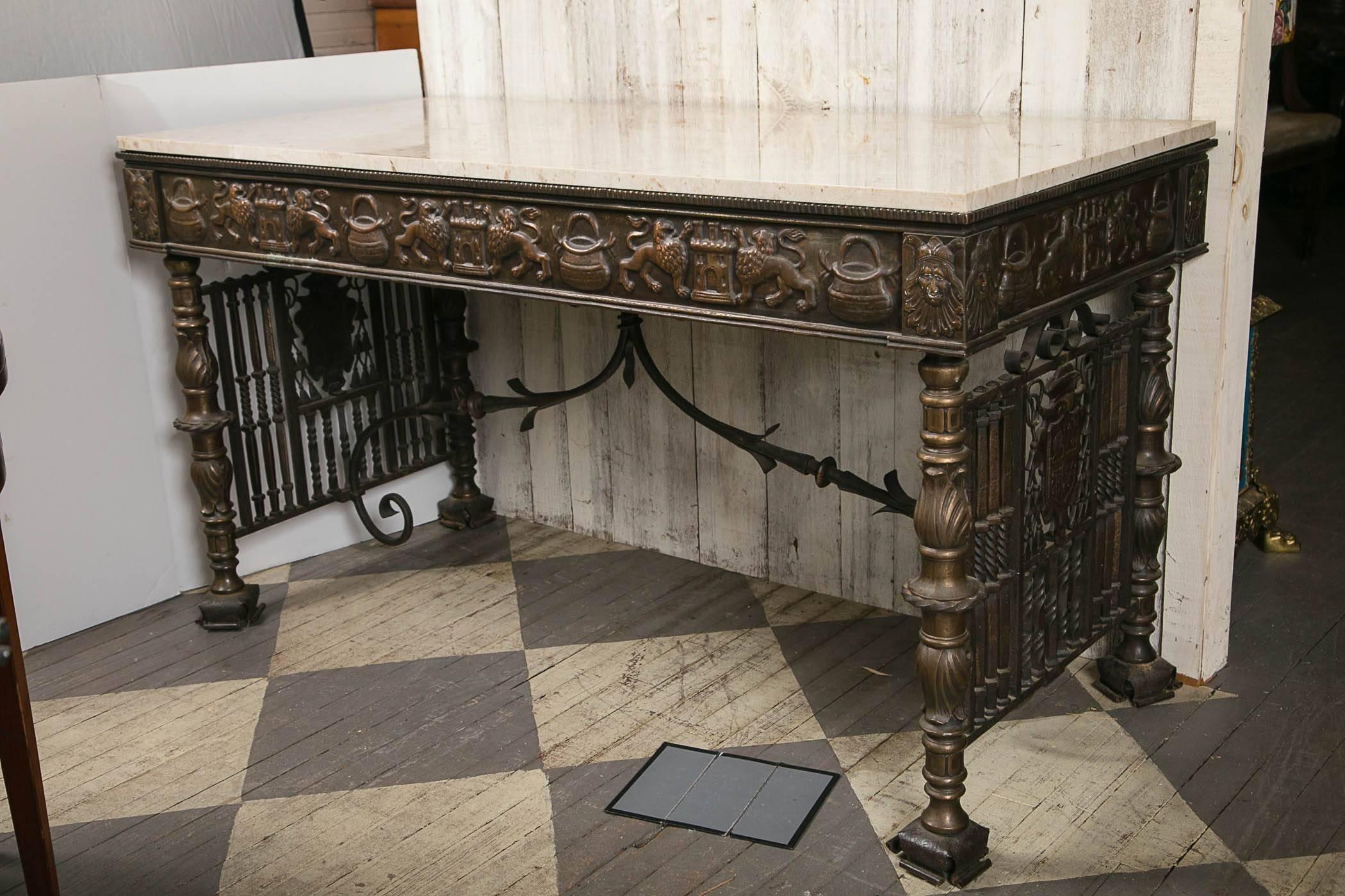This table was possibly made by Oscar Bach. It is decorated all around to be used as a center table, but can also be a console or serving table. The tan marble is squared edged. The frieze is decorated with in repousse. The end vertical bars are of