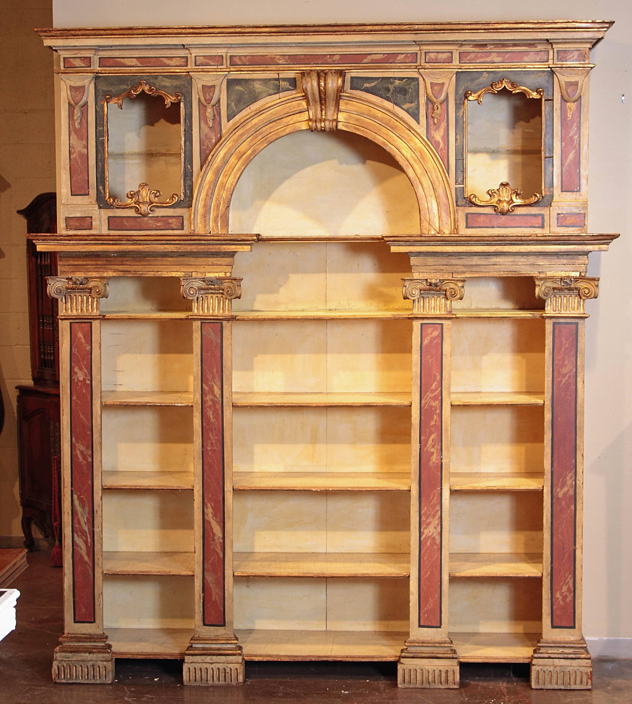 Add extra shelving to your living room, library or study with this important antique carved open bookcase. Crafted in Northern Italy, circa 1820, and built in three sections, this elegant faux marble display cabinet features five shelves across the