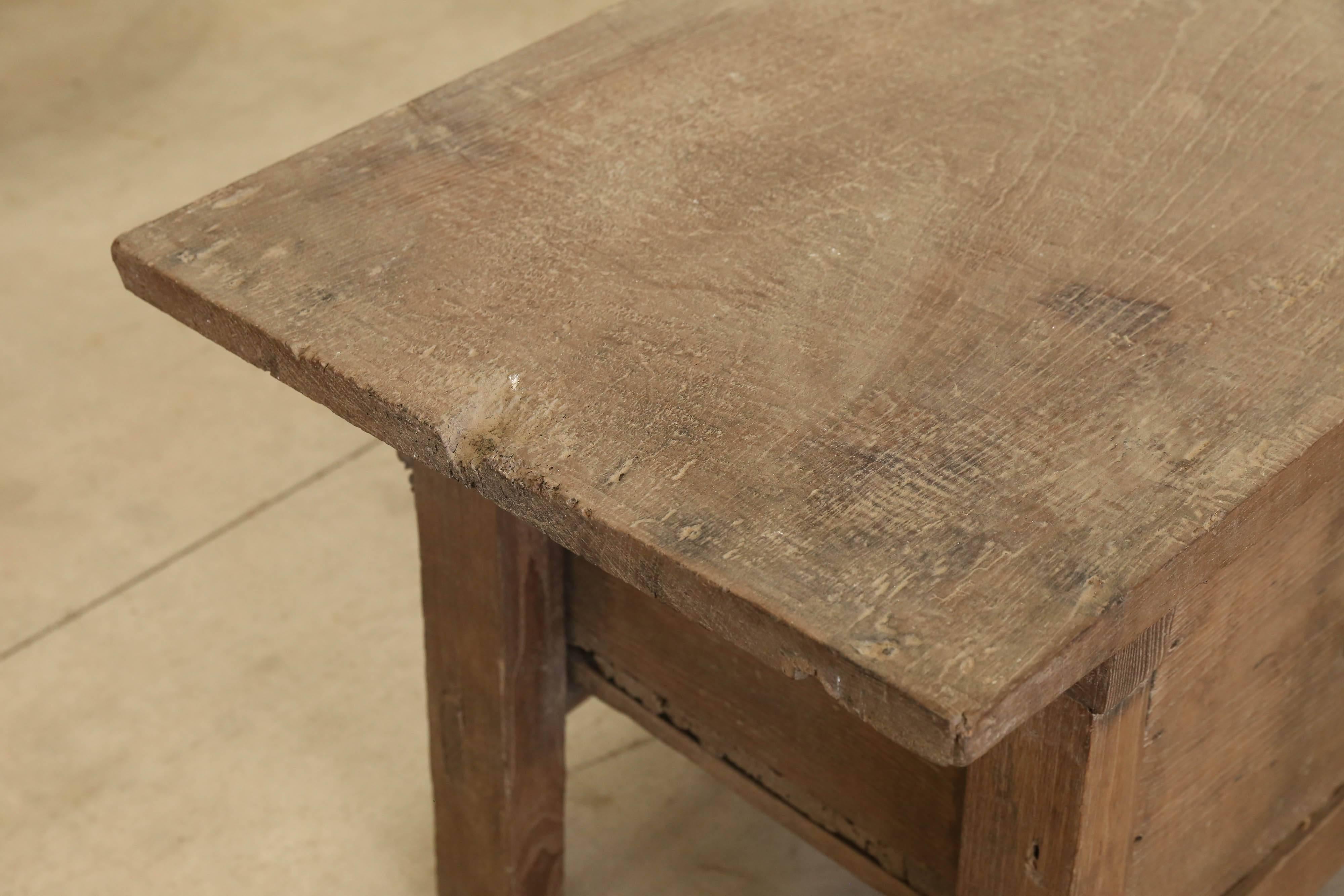 This is a rustic chestnut Spanish table with handsome iron handles on the drawer and rare single board top. Terrific coffee table.