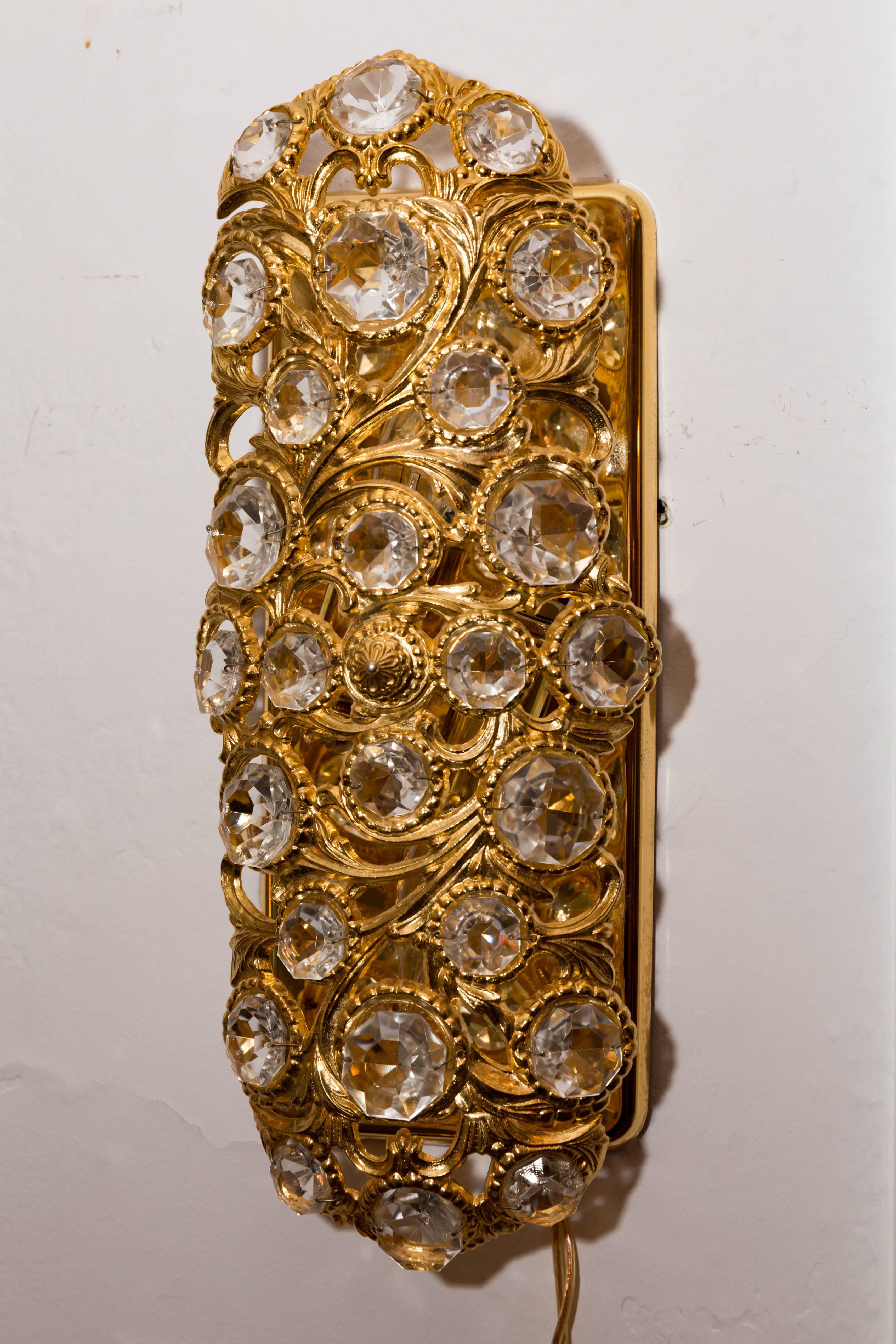 Pair of gilt metal tendril sconces with inset crystal details.