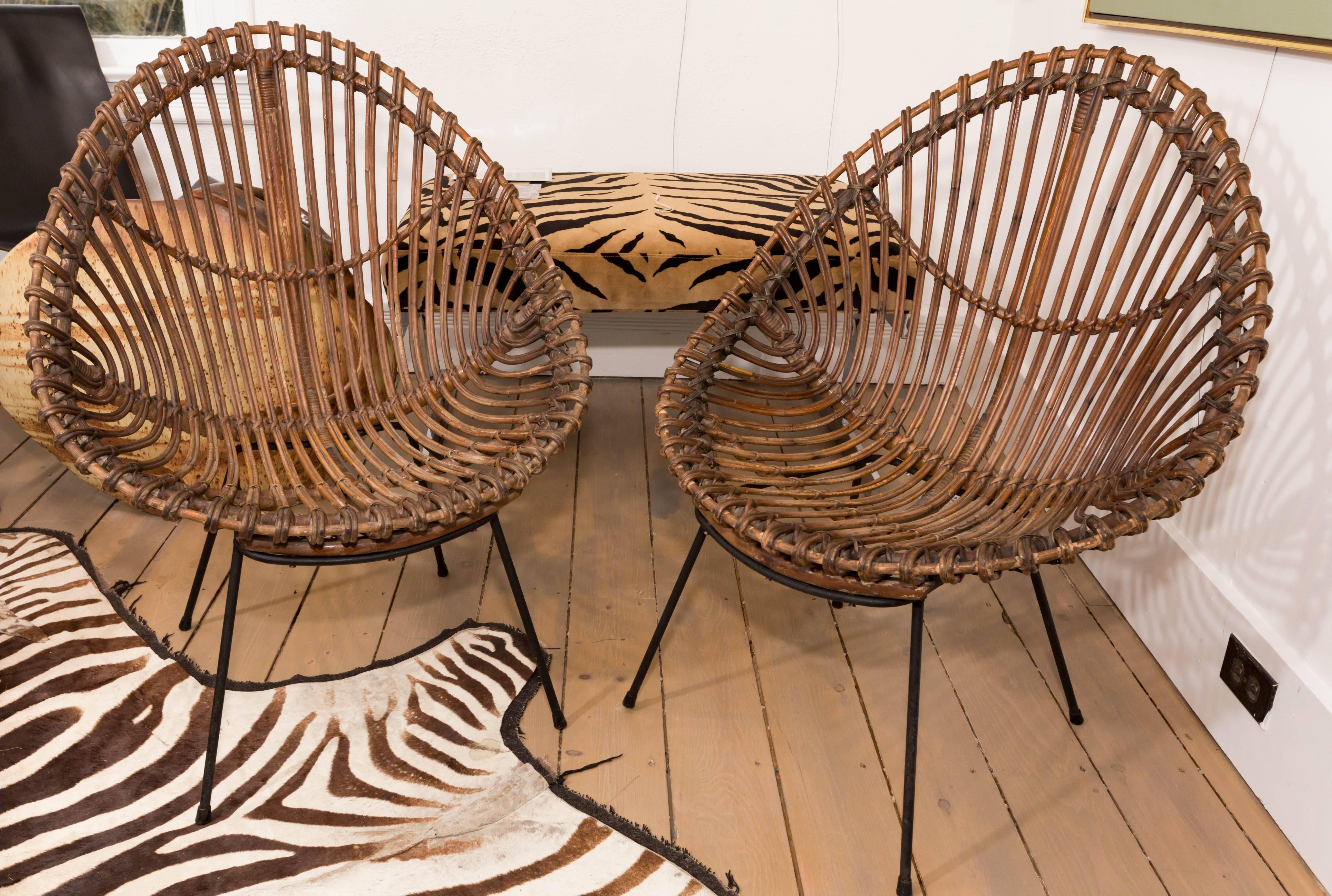 Pair of bamboo chairs with black metal bases.