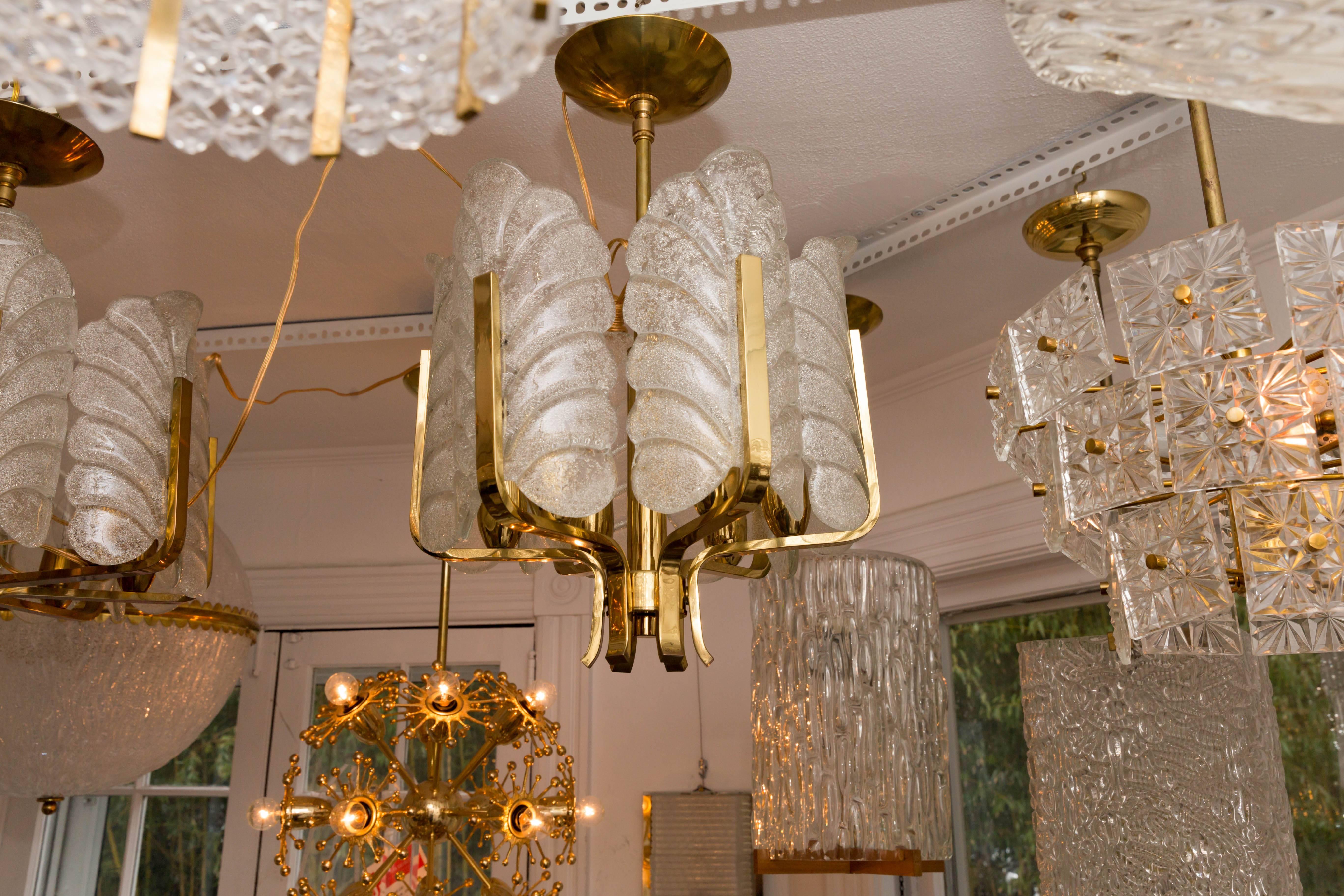 Brass six-arm chandelier with frosted upright acanthus shades
by Karl Fagerlund for Orrefors.