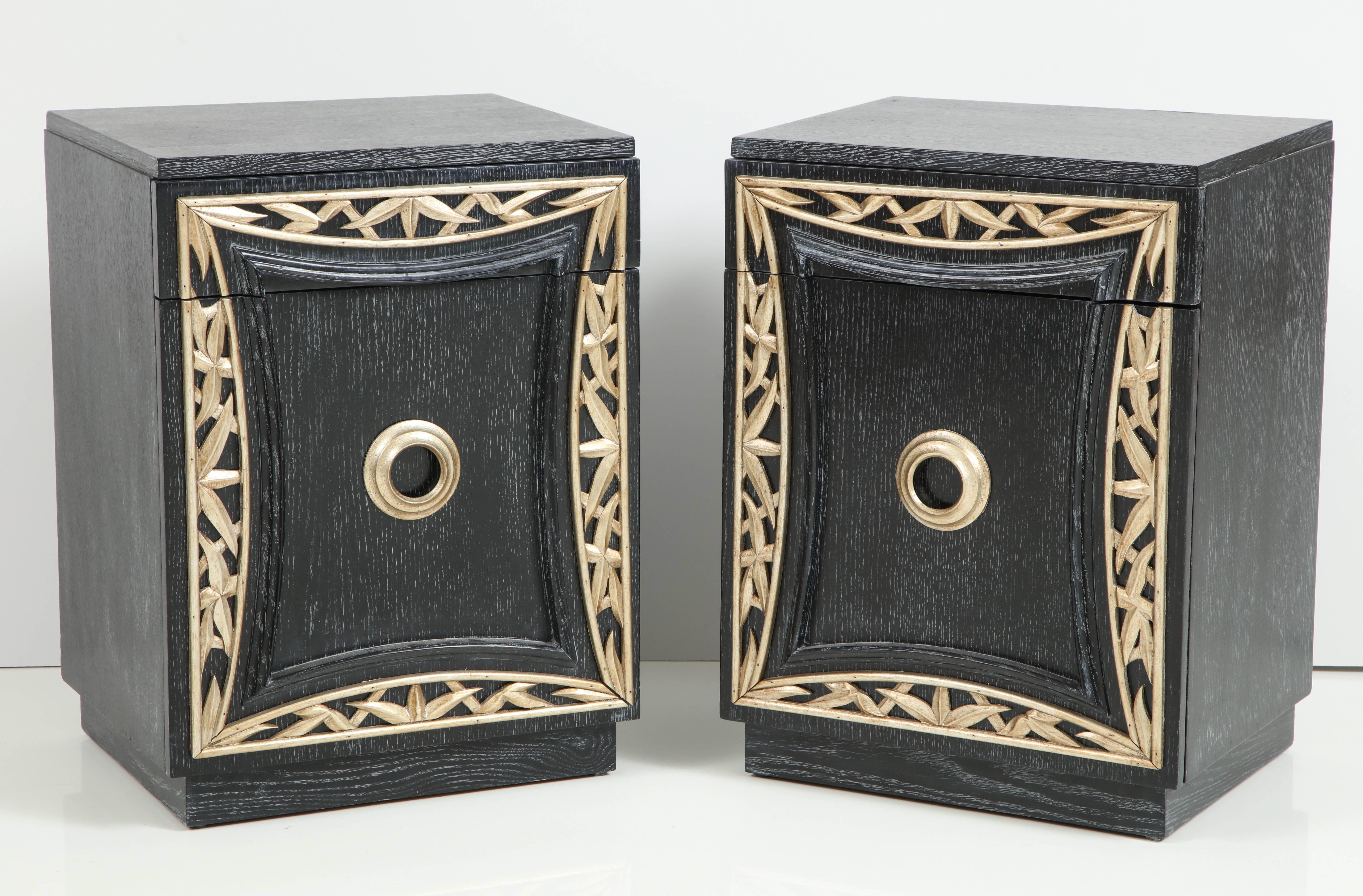 Elegant pair of end cabinets / nightstands by James Mont.
The cabinets have been beautifully refinished in a dark blue / black cerused oak finish which is enhanced by a decorative carved bamboo fret work in a glazed silver leaf.