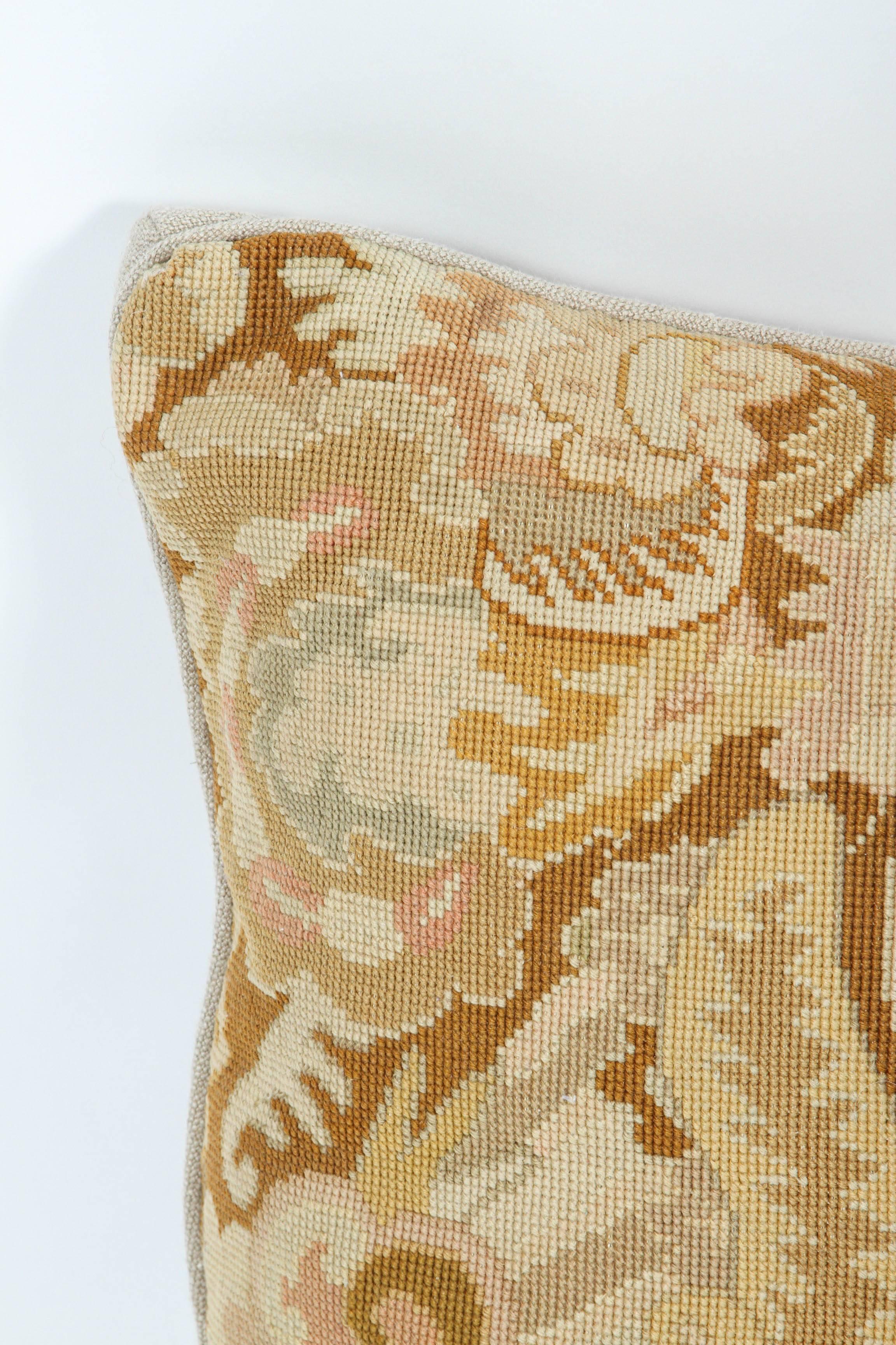 Vintage needlepoint fabric newly made into a pillow with vintage linen back and new feather fill.