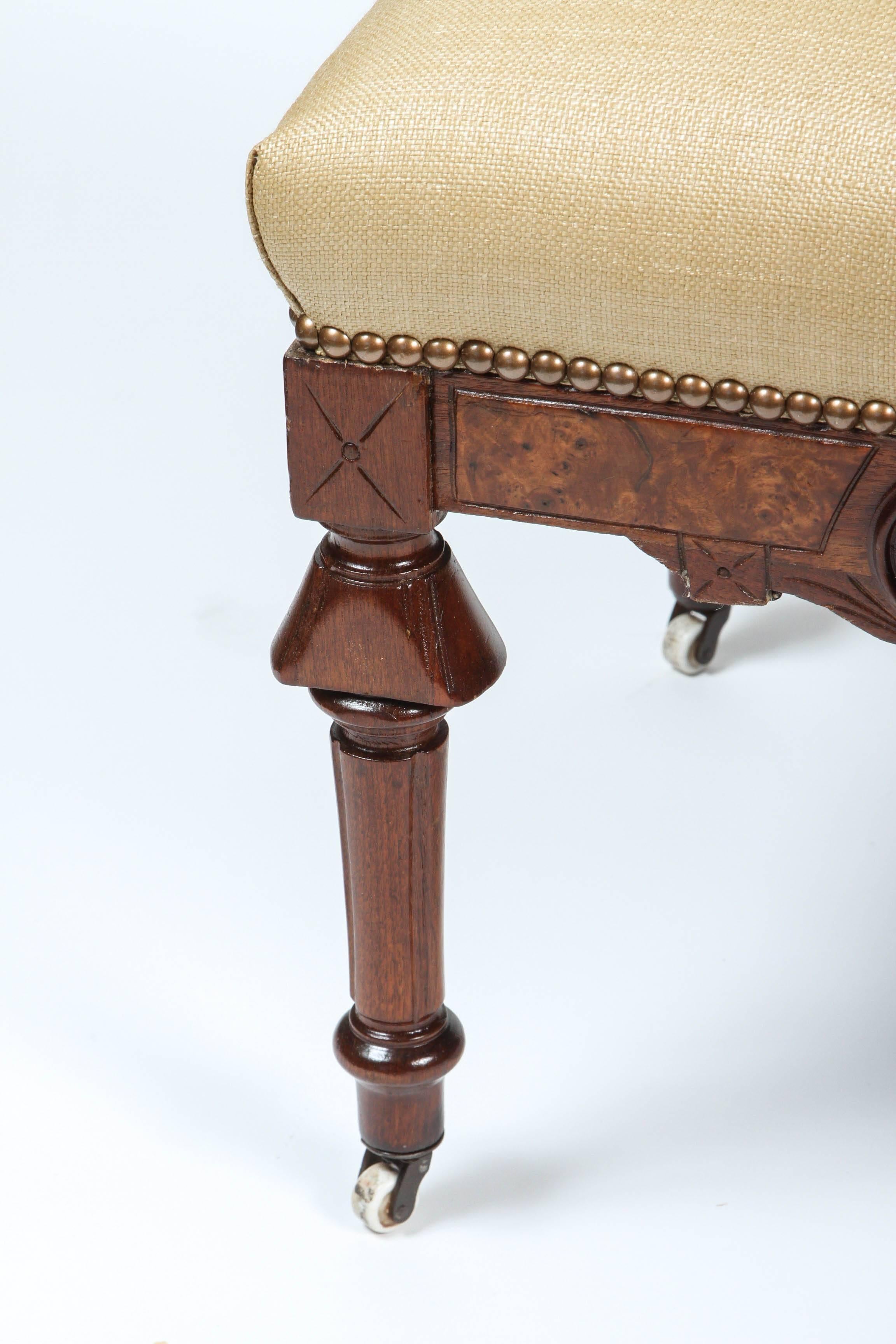 Newly refinished and upholstered antique Eastlake stool on casters, with nailhead trim.