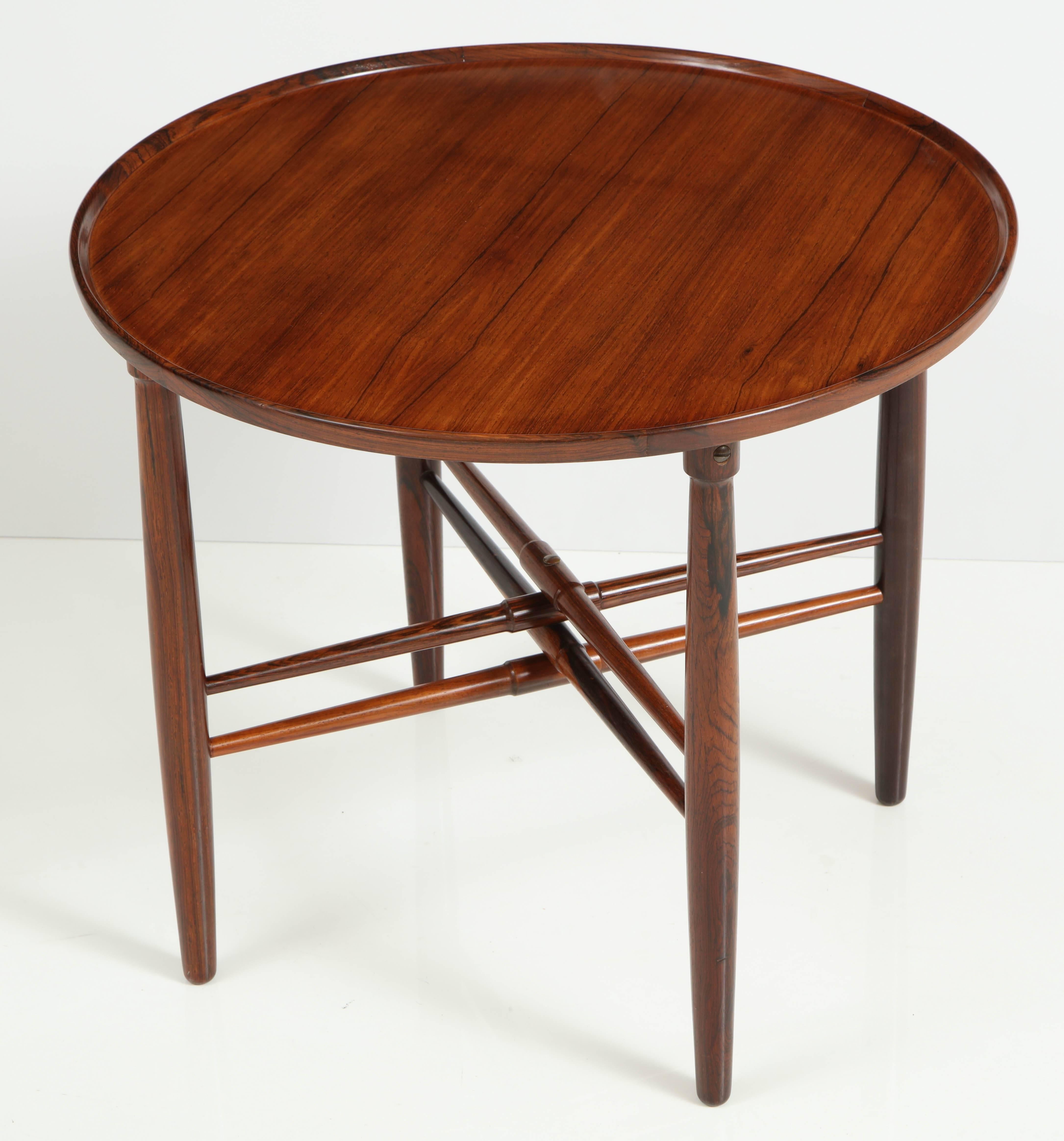 A good Danish rosewood side table, circa 1940s, the circular lipped top above for tapered turned legs joined by double turned and tapered X-form stretchers. Very nice quality table in both material and cabinetmaking.