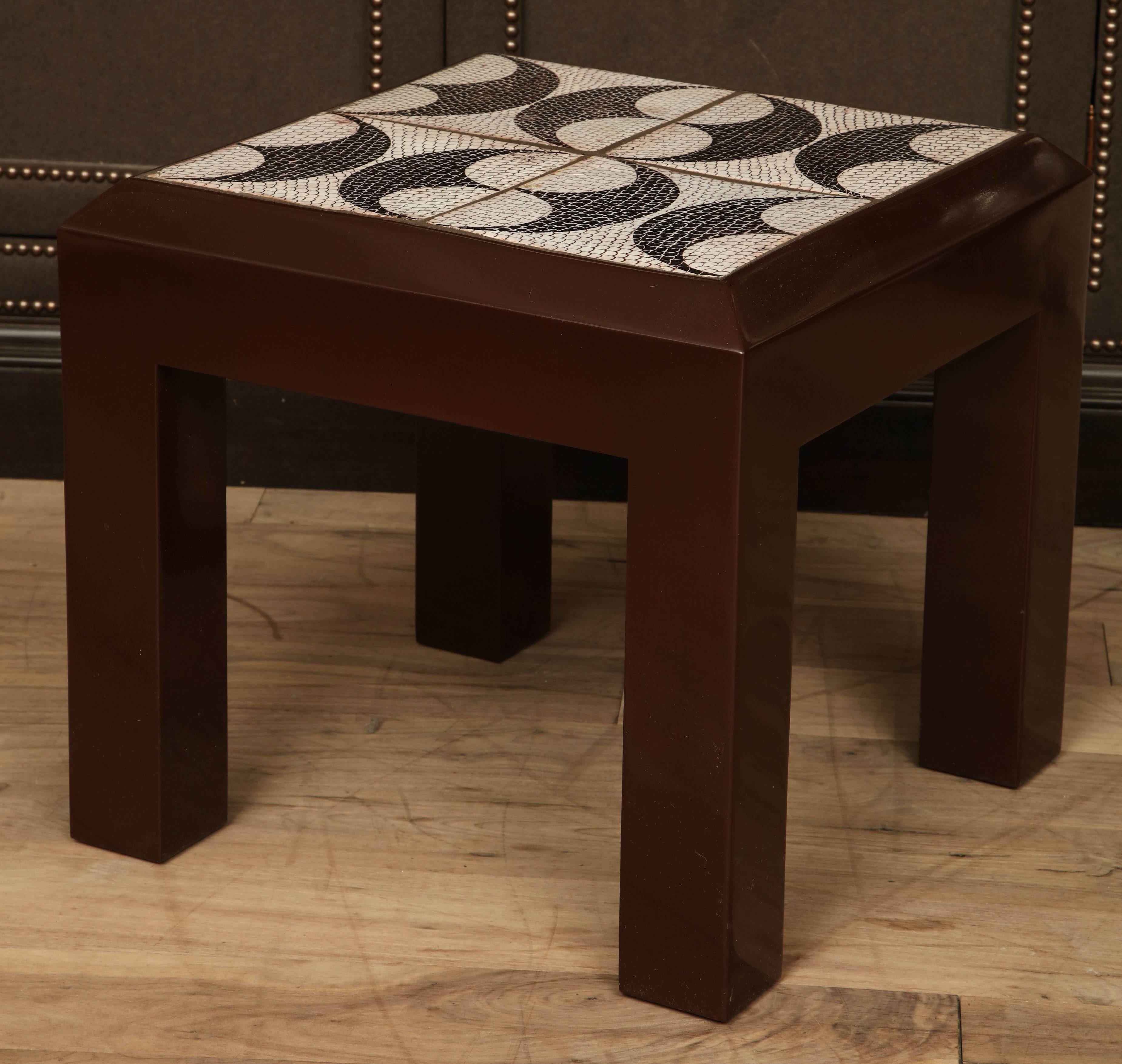 Lacquered maple side table with inset tile top with black and white fish scale and shield pattern, circa 1950.