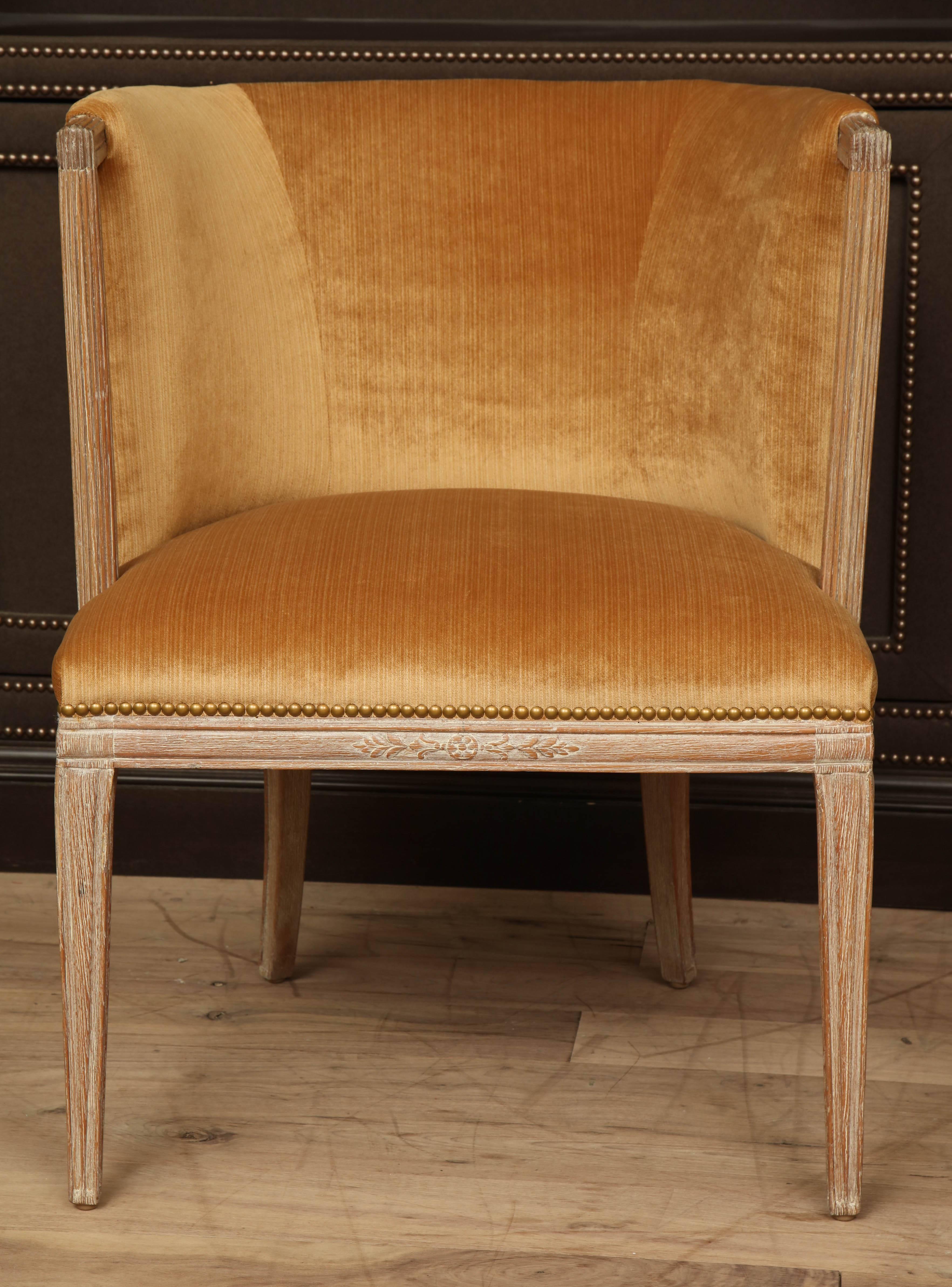 Brushed oak armchair by Grosfeld House, circa 1940 with reeded, open arms and recently reupholstered in apricot strie velvet.