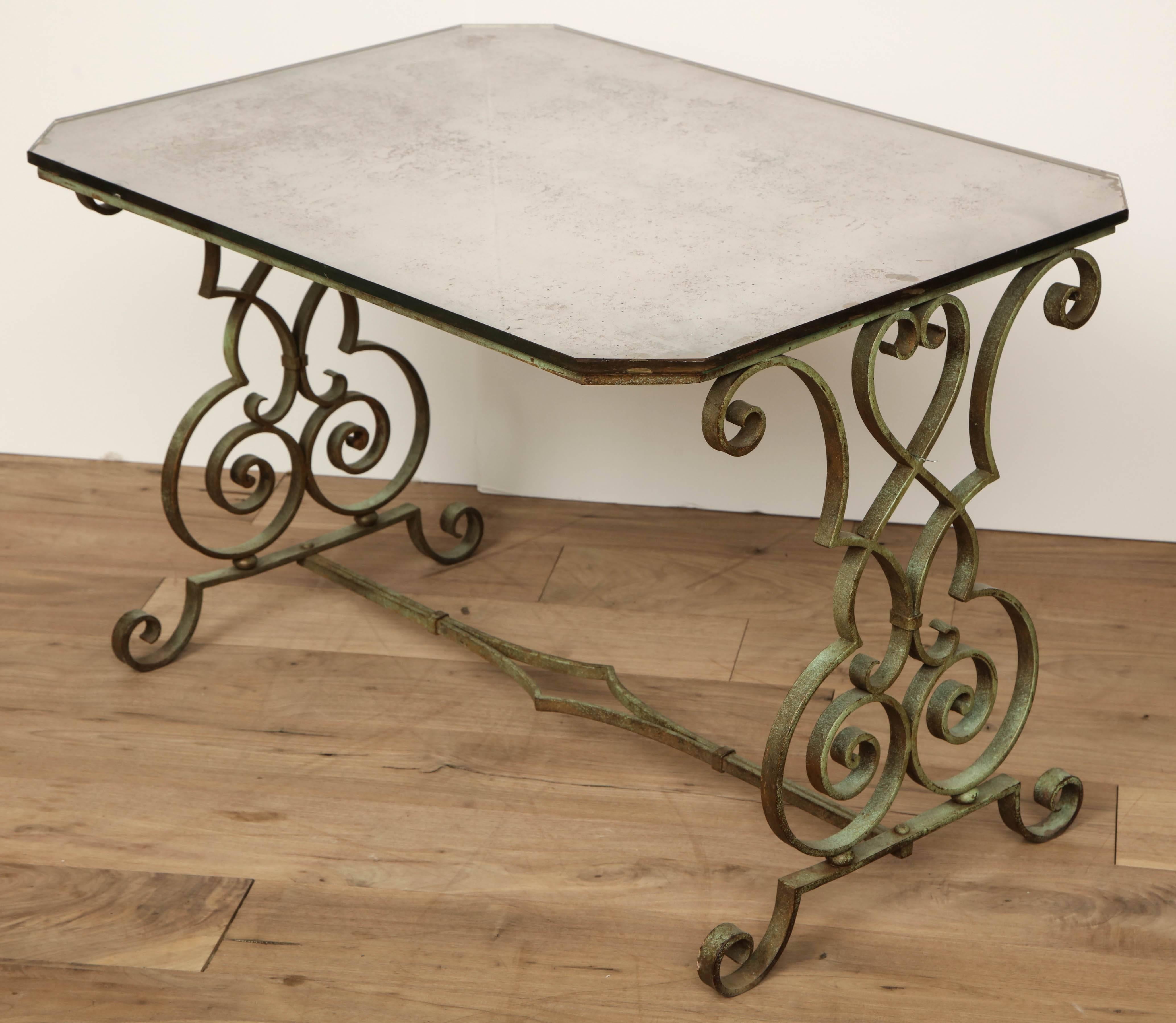 Iron side table with verdigris and antique mirror top, circa 1950.