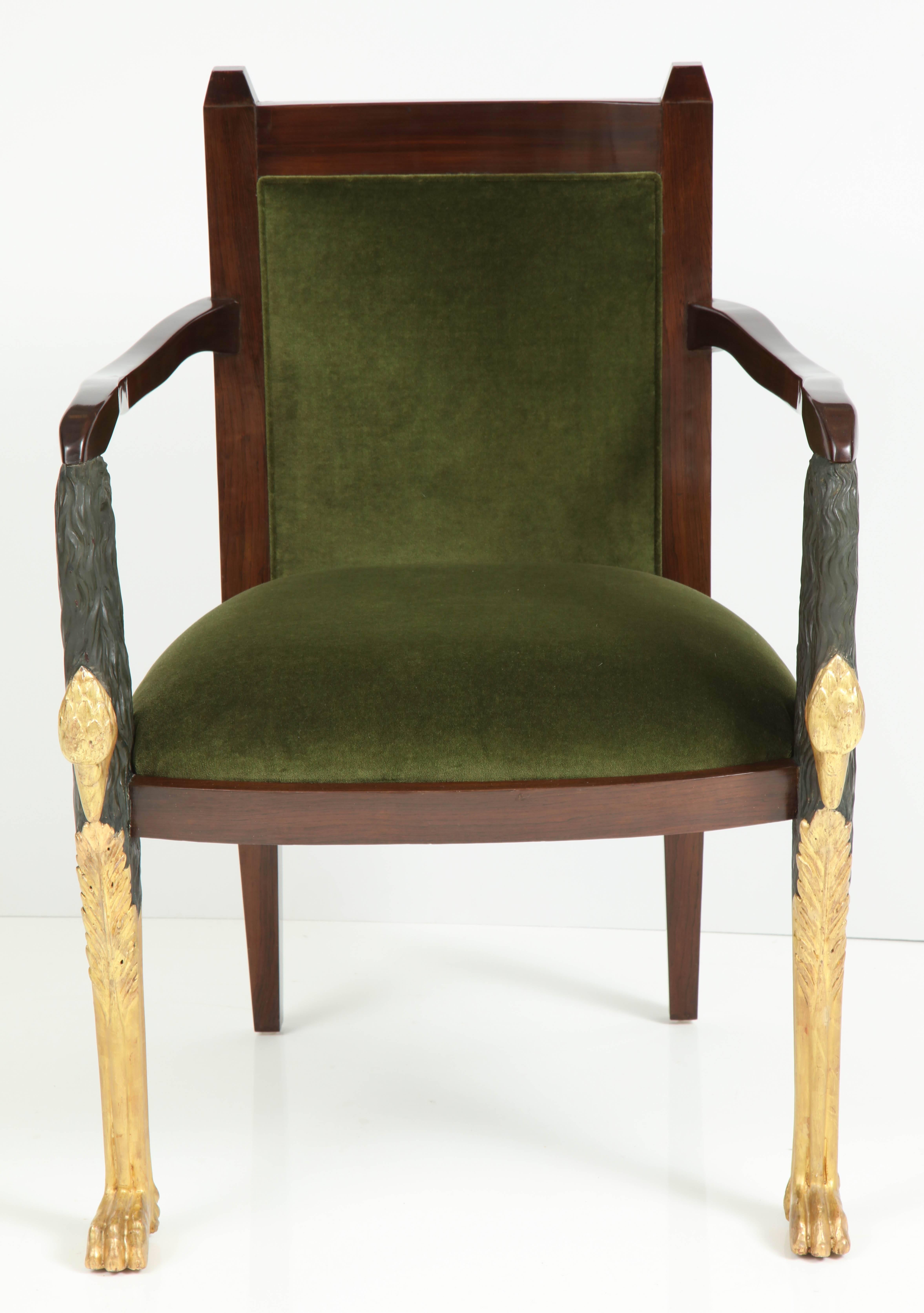 Stunning Regency style armchair featuring a Fruitwood frame with hand-carved matte ebonized plume body details and traditional 22-karat gilded parcel gilt detail on stylized heron heads at arm fronts and legs. Mint restored with new Moss Green