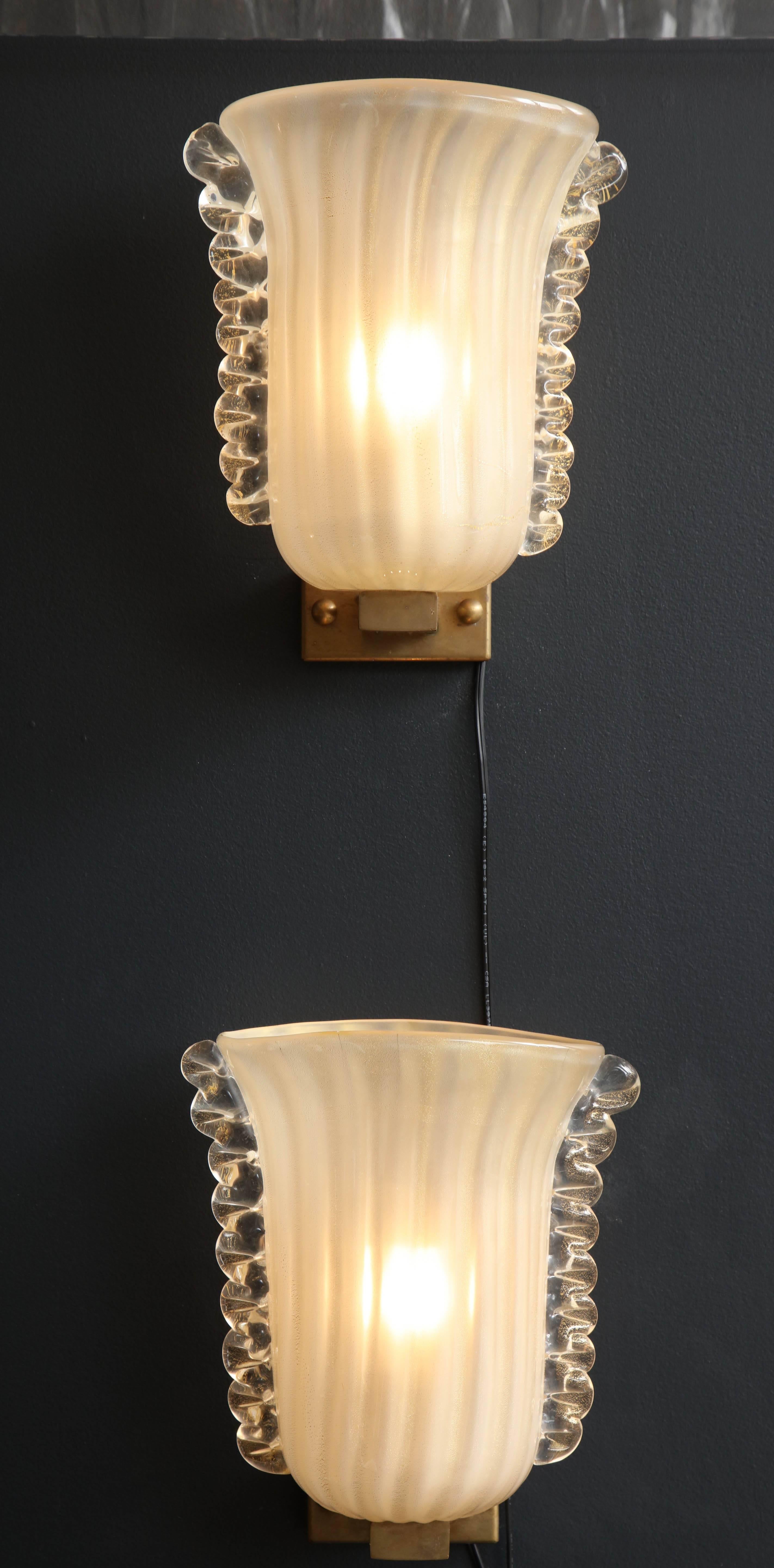 These rare pair of Italian sconces are a piece of art. Handblown and handcrafted as only the Italian masters can do. Ivory colored glass (handmade from Italian silica sand) infused with 23-carat 