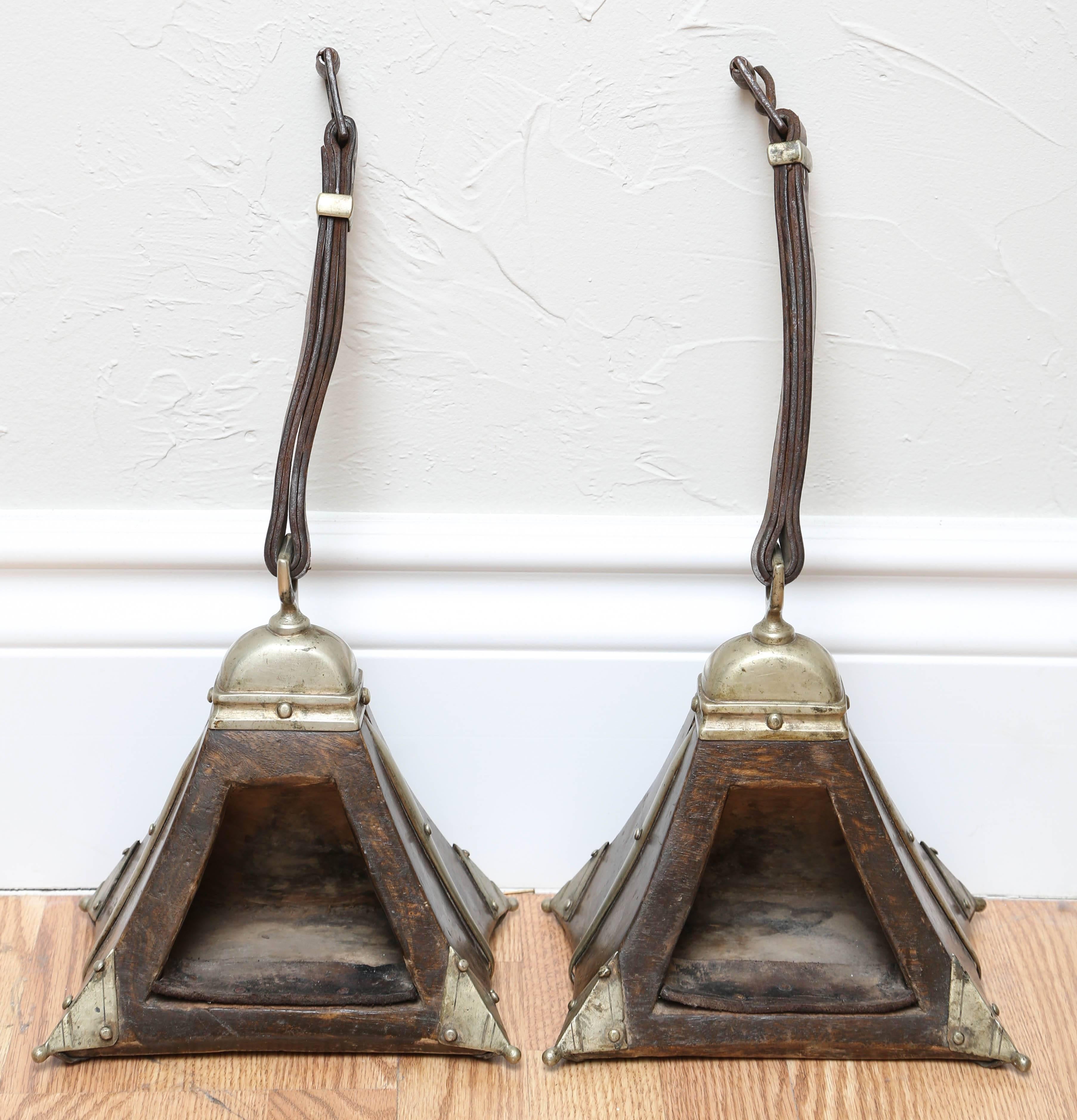 Unique pair of wood and silver plate Guacho stirrups with leather straps and lining.