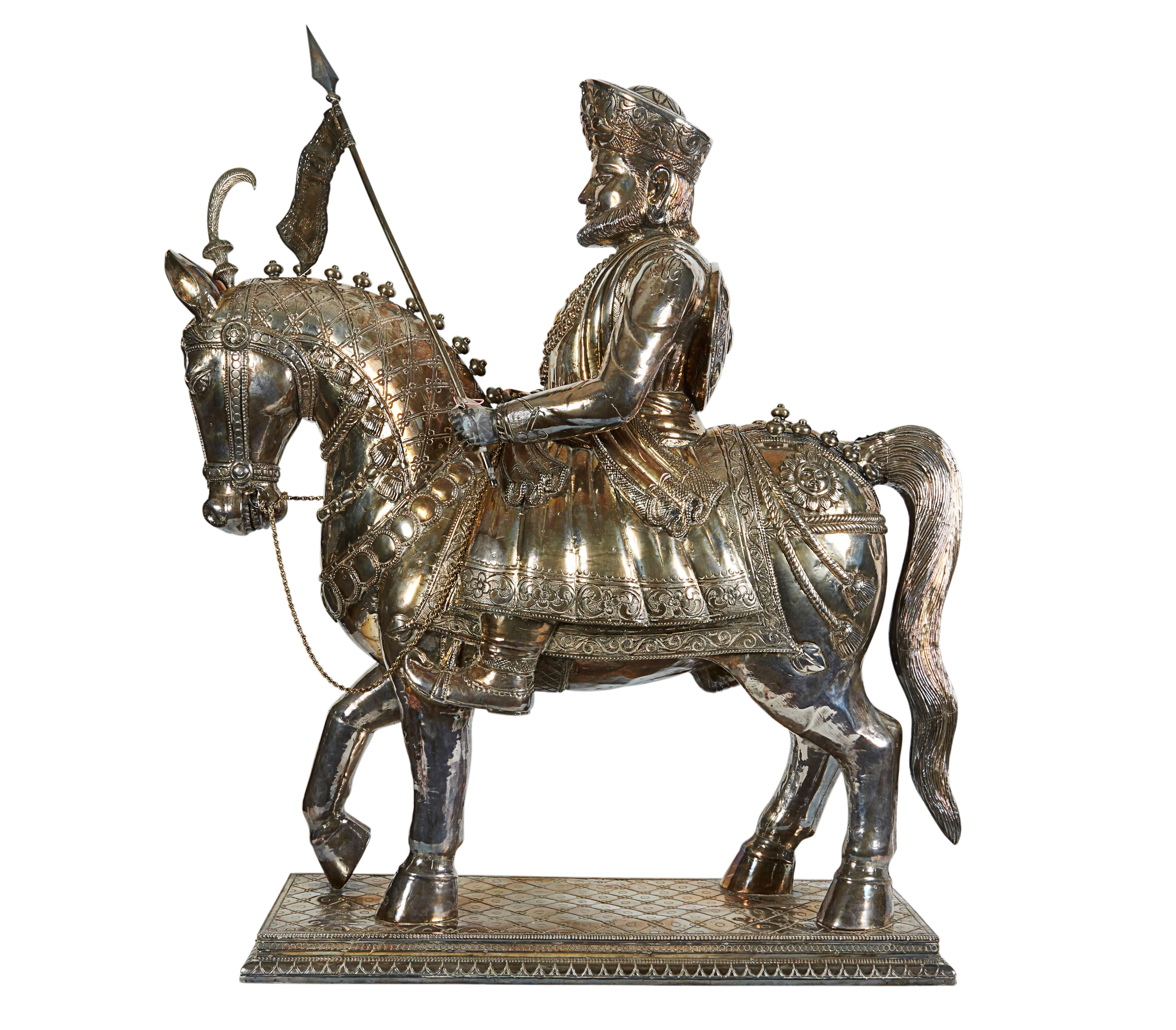 A monumental colonial Indian silver over wood figure of a Bombay Cavalryman.

India, early 20th century.

This monumental sculpture in the form of a well-dressed cavalryman on horseback, comprised of carved wood overlaid with sheets of pure