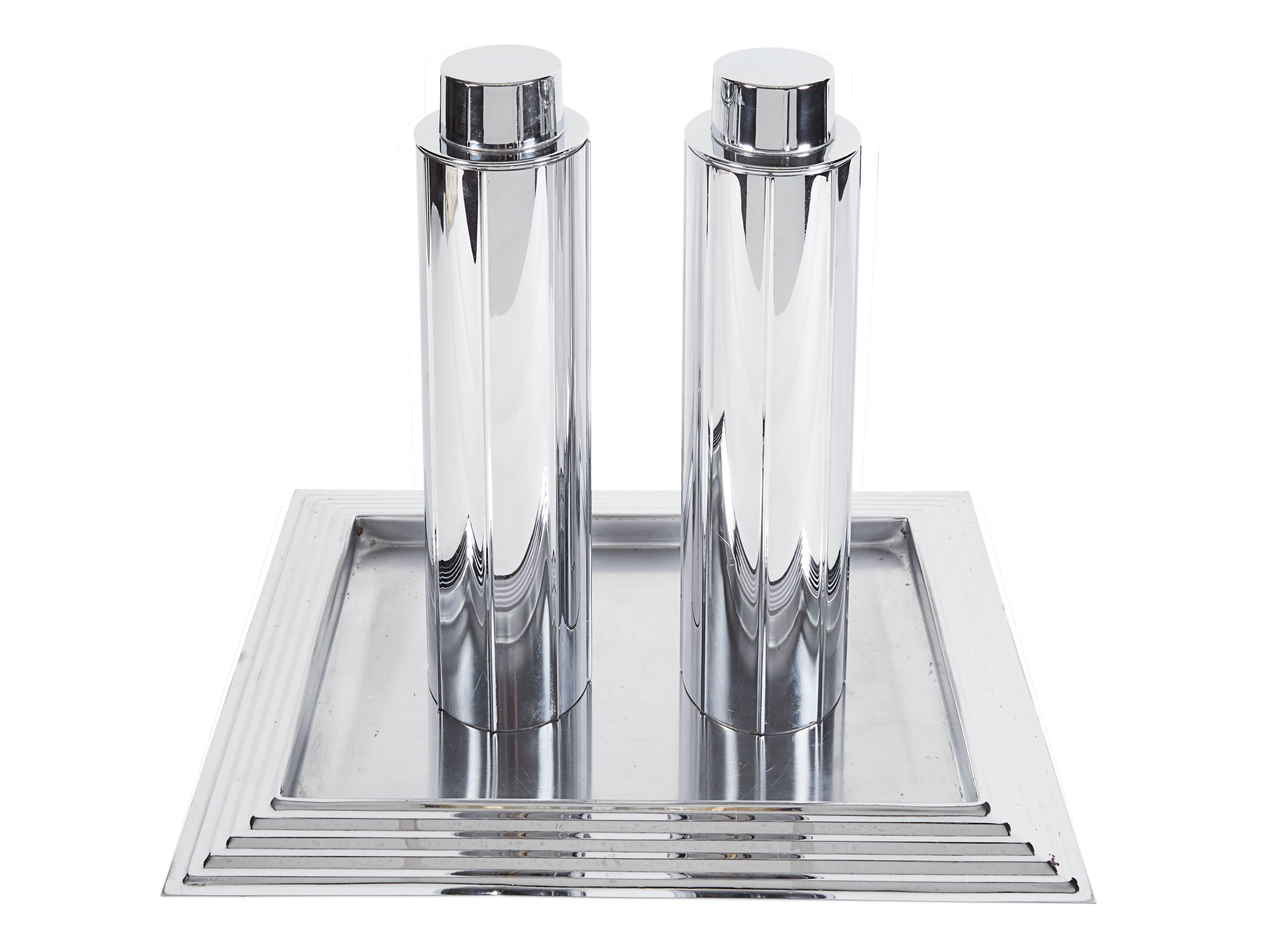 Norman Bel Geddes (1893-1958) for Revere, Manhattan pair of cocktail shakers and tray, Rome, NY, USA.

1930s, chromed steel, stamped marks

Measures: Shakers 3.5