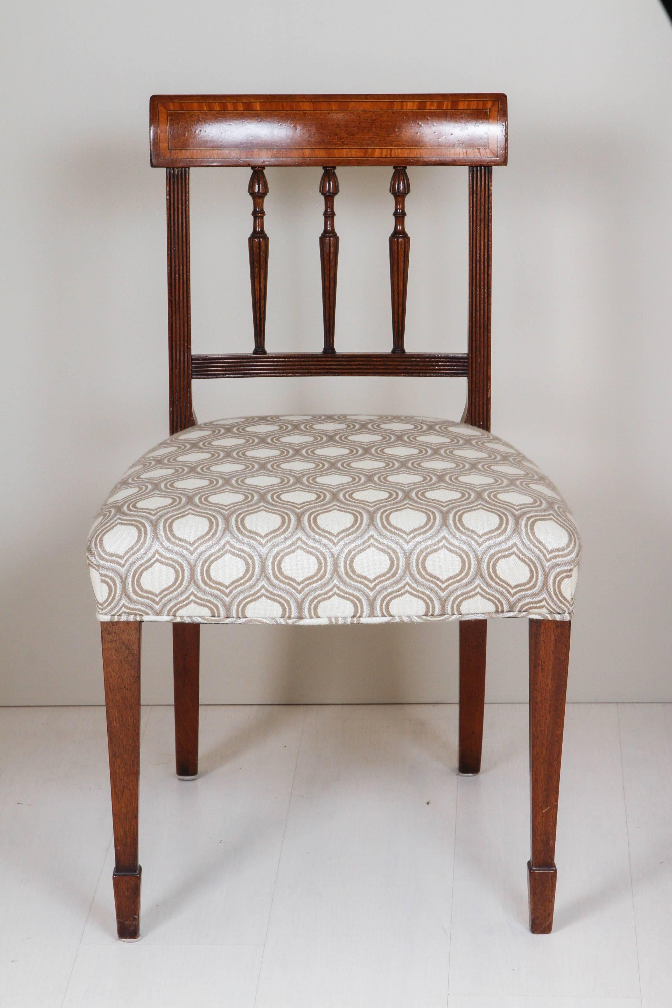 Set of six wooden chairs with re-upholstered seating.