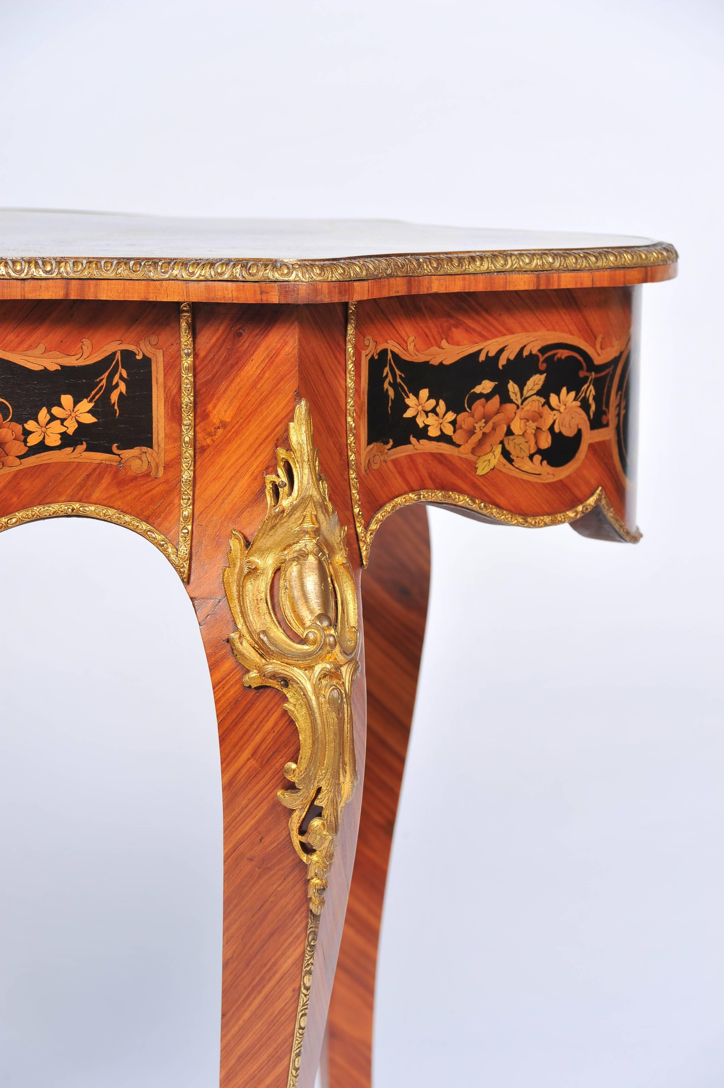 A very good quality French 19th century Louis XV style marquetry inlaid centre table. Having wonderful scrolling and foliate decoration to the top and sides, ormolu mounts, a single frieze drawer and raised on elegant cabriole legs.