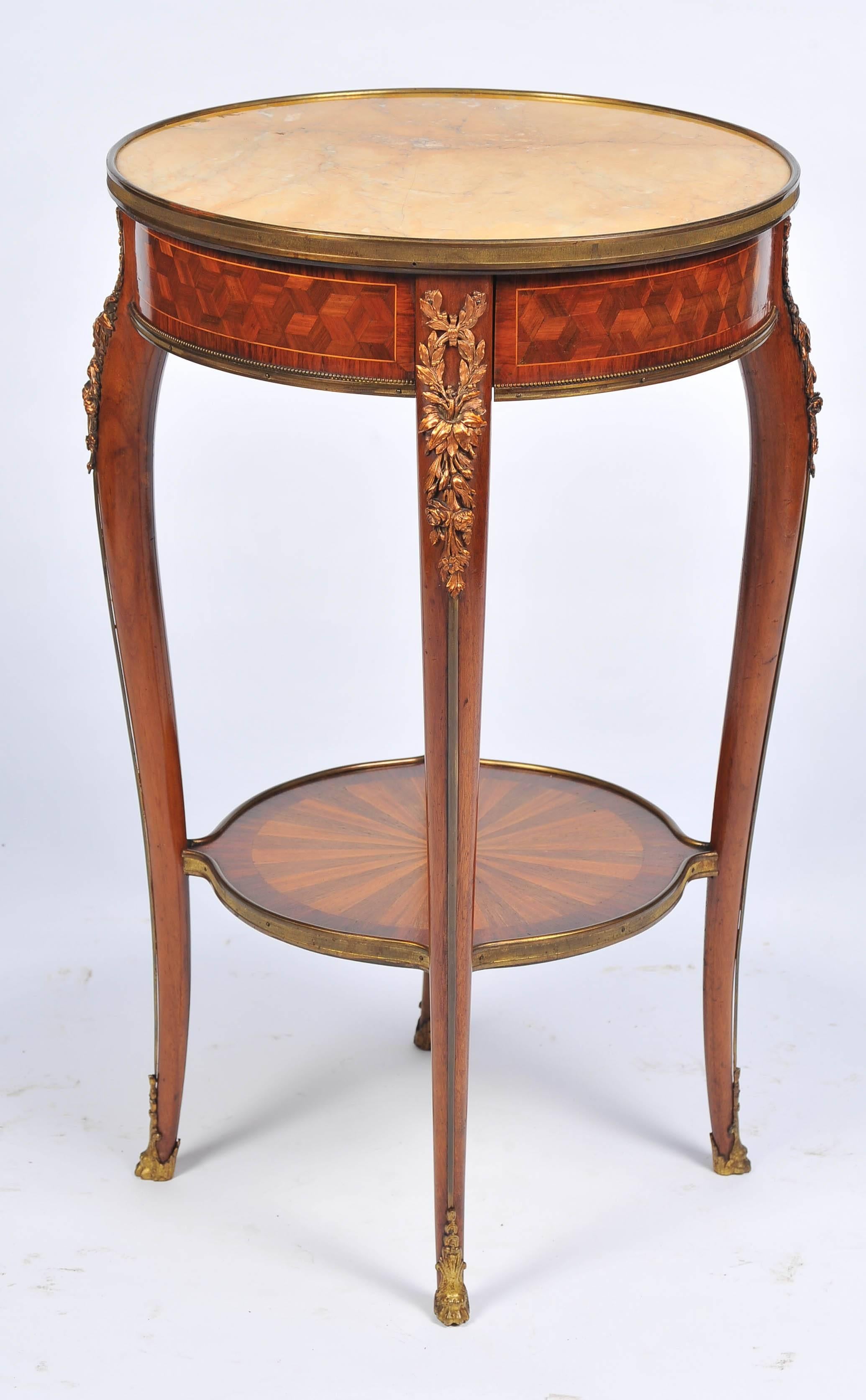 A 19th century French kingwood occasional table, having a sienna marble top, ormolu mounts, a single frieze drawer, raised on four cabriole legs, united by a circular under-tier which has radiating inlaid decoration.