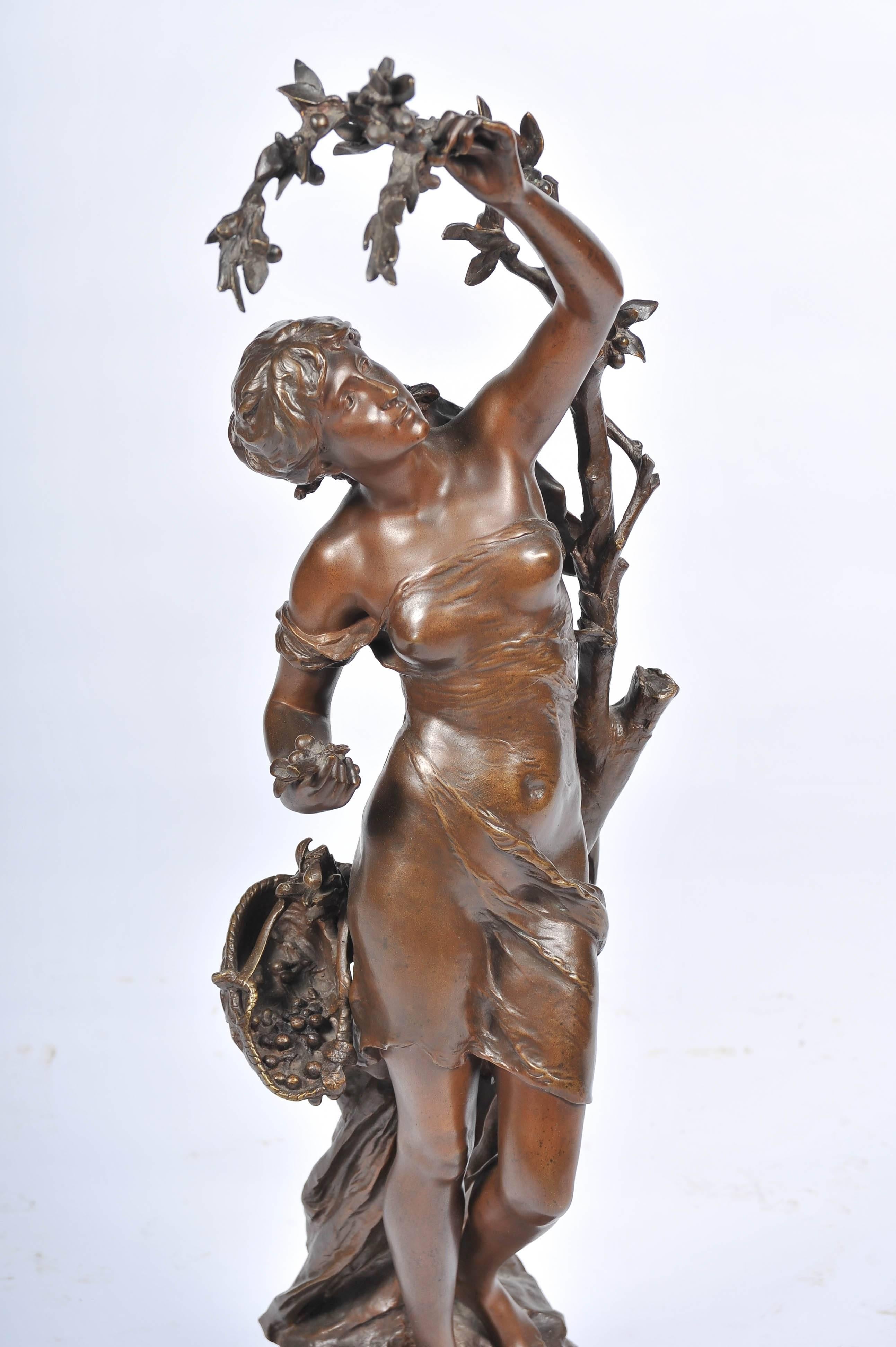 A very good quality, beautifully patinated bronze statue of a semi clad young girl picking cherries.
Signed: Math. Moreau.