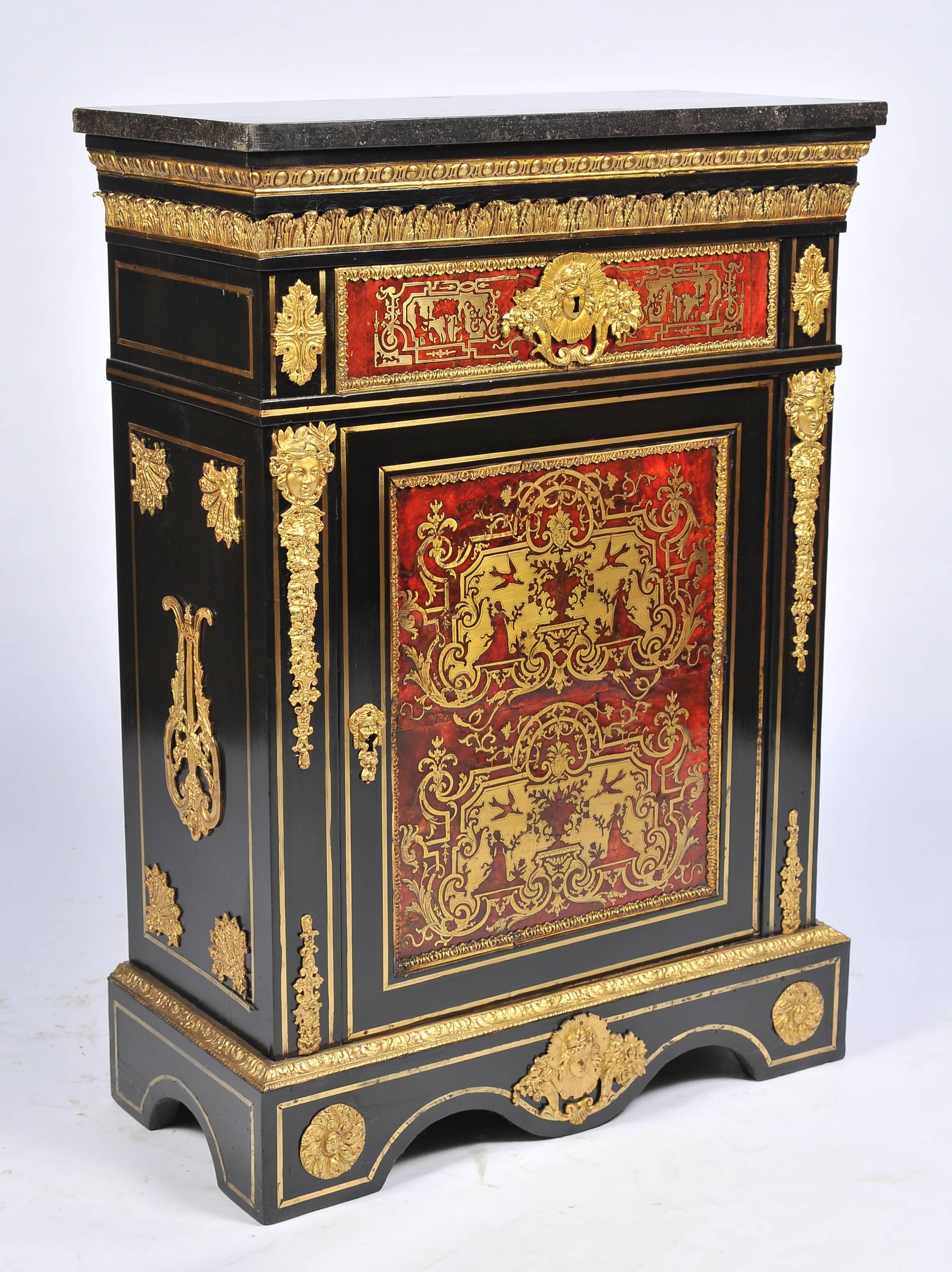 A very good quality French, 19th century Boulle side cabinet. Having its original marble top, gilded ormolu mounts. A single frieze drawer with a gilded handle. The door opens to reveal a shelf within. The brass inlaid decoration depicting birds,