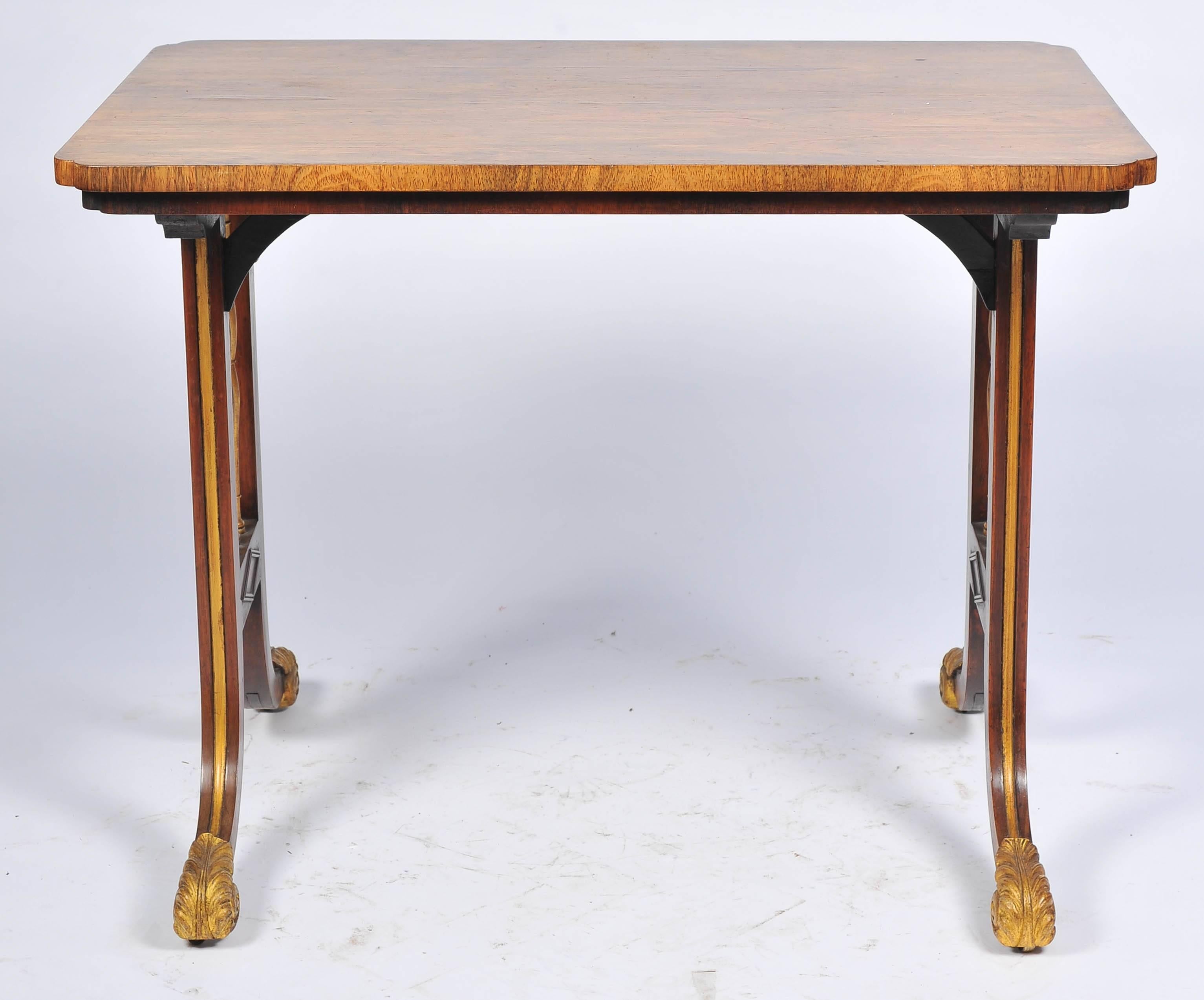 A very good quality Regency period rosewood and parcel-gilt side table, having end supports with gilded decoration, out swept supports terminating in scrolling ormolu castors.