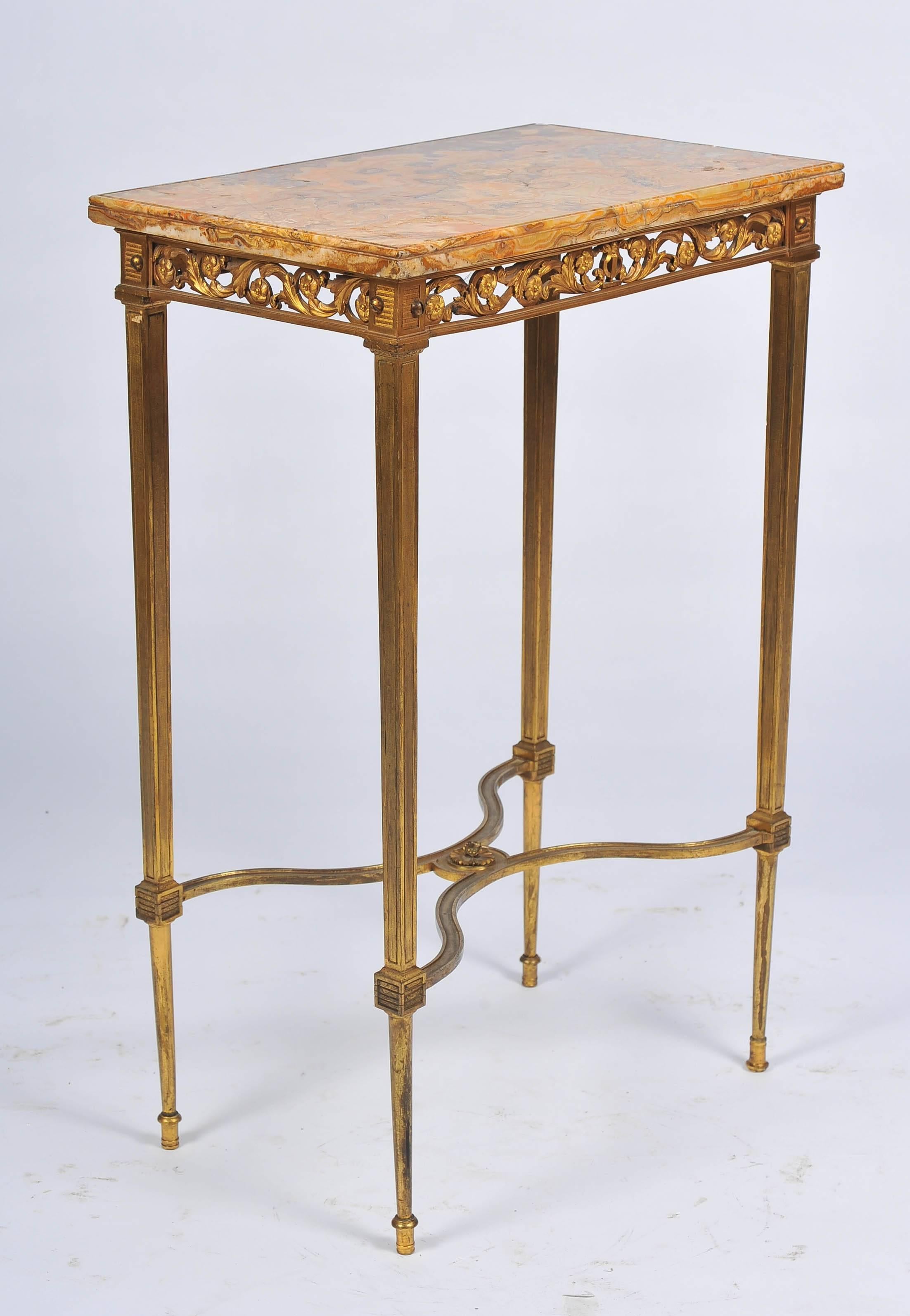 A good quality late 19th century gilded ormolu, Sienna marble topped Louis XVI style side table Having pierced scrolling foliate decoration to the frieze and raised on square tapering legs, united by an cross stretcher.