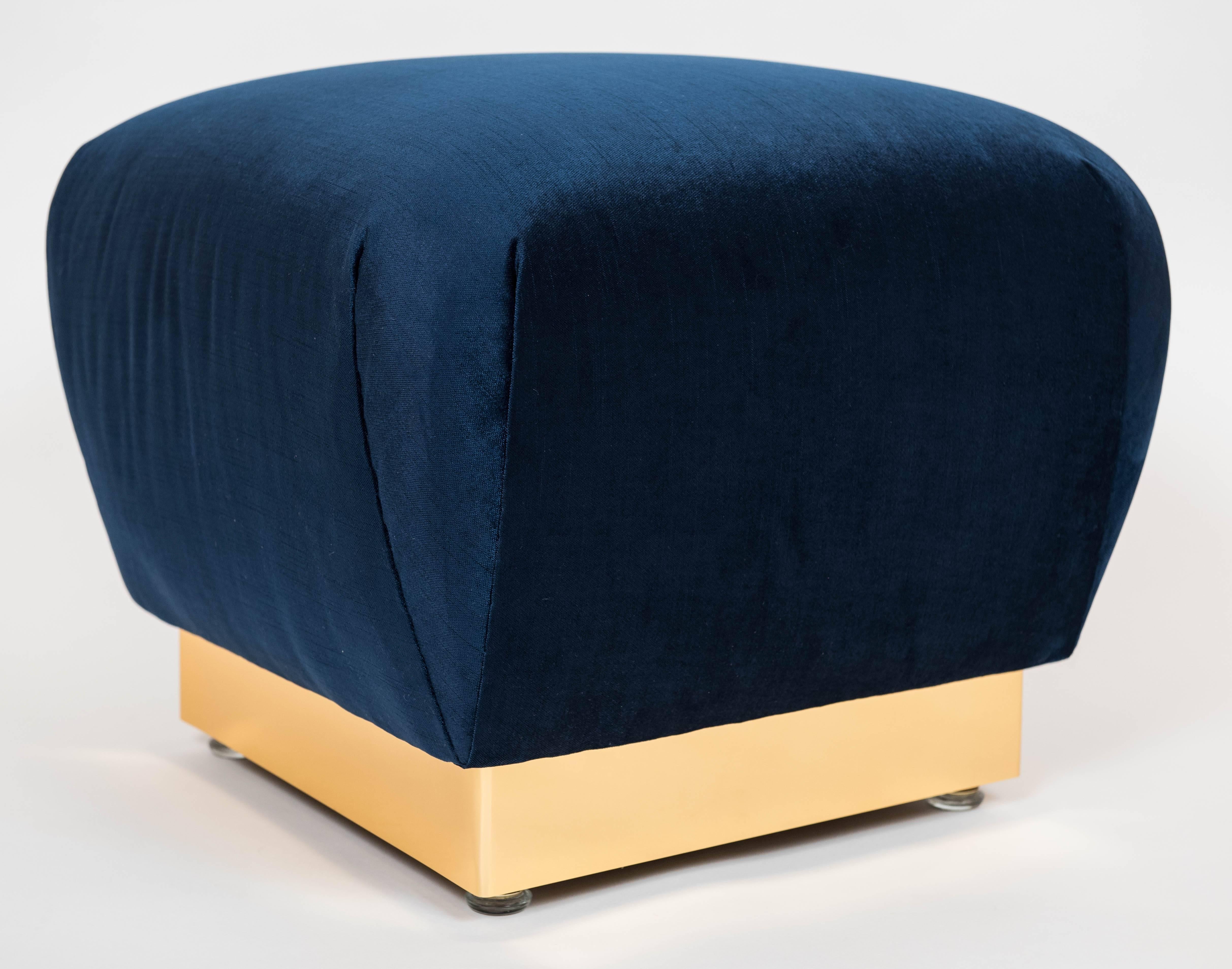 These decadent and stylish poufs have been fully restored with a rich brass tone colored metal trim and new royal blue upholstery. They are in the style made popular by Karl Springer in the 1970s.