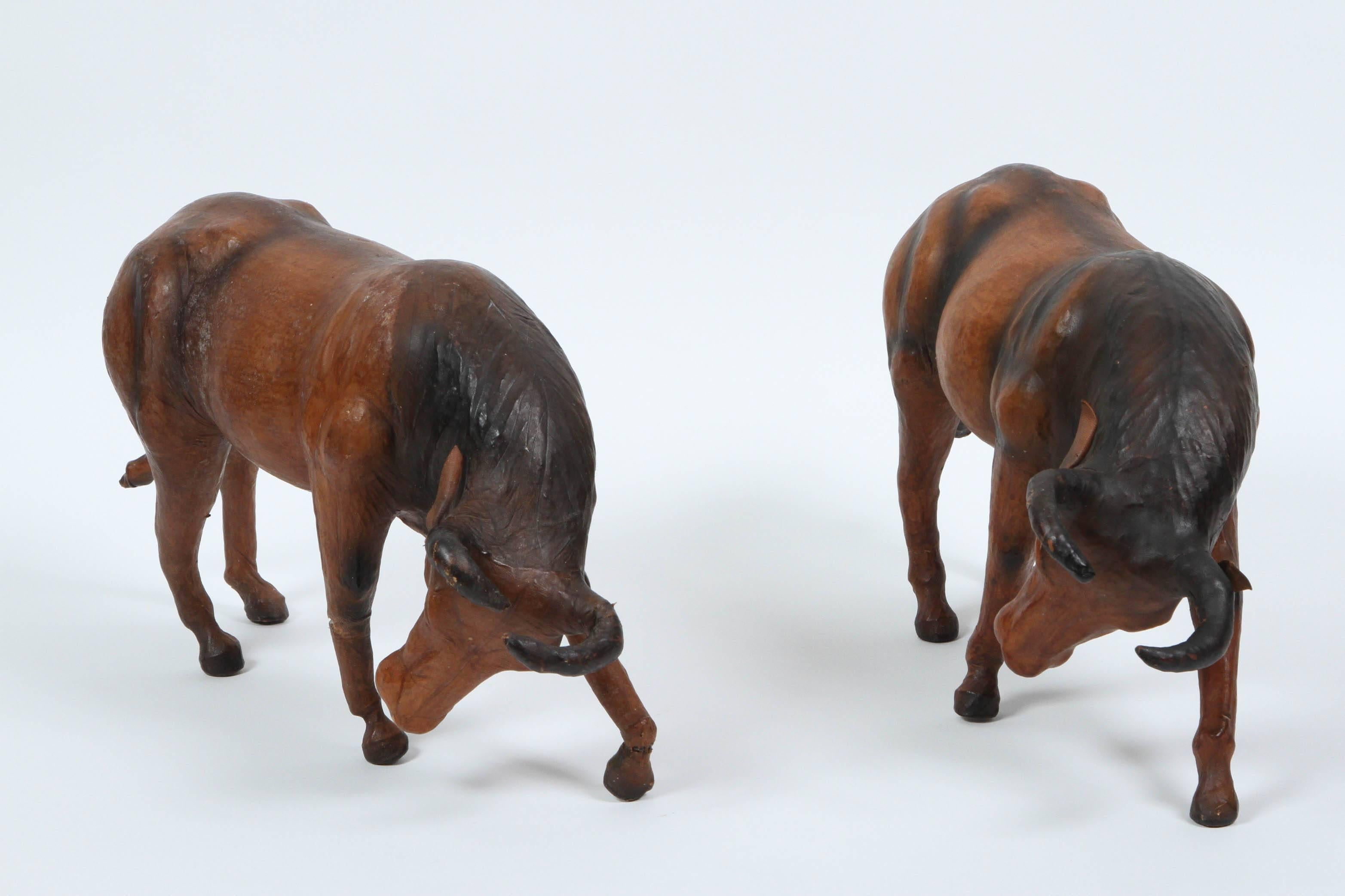 Pair of vintage leather wrapped fighting bulls in dark brown and black.
Hand tooled leather wrapped Spanish bulls.
Great decorative leather animals sculpture covered in thin and richly tanned leather, having inset glass eyes
Wonderful aged patina to