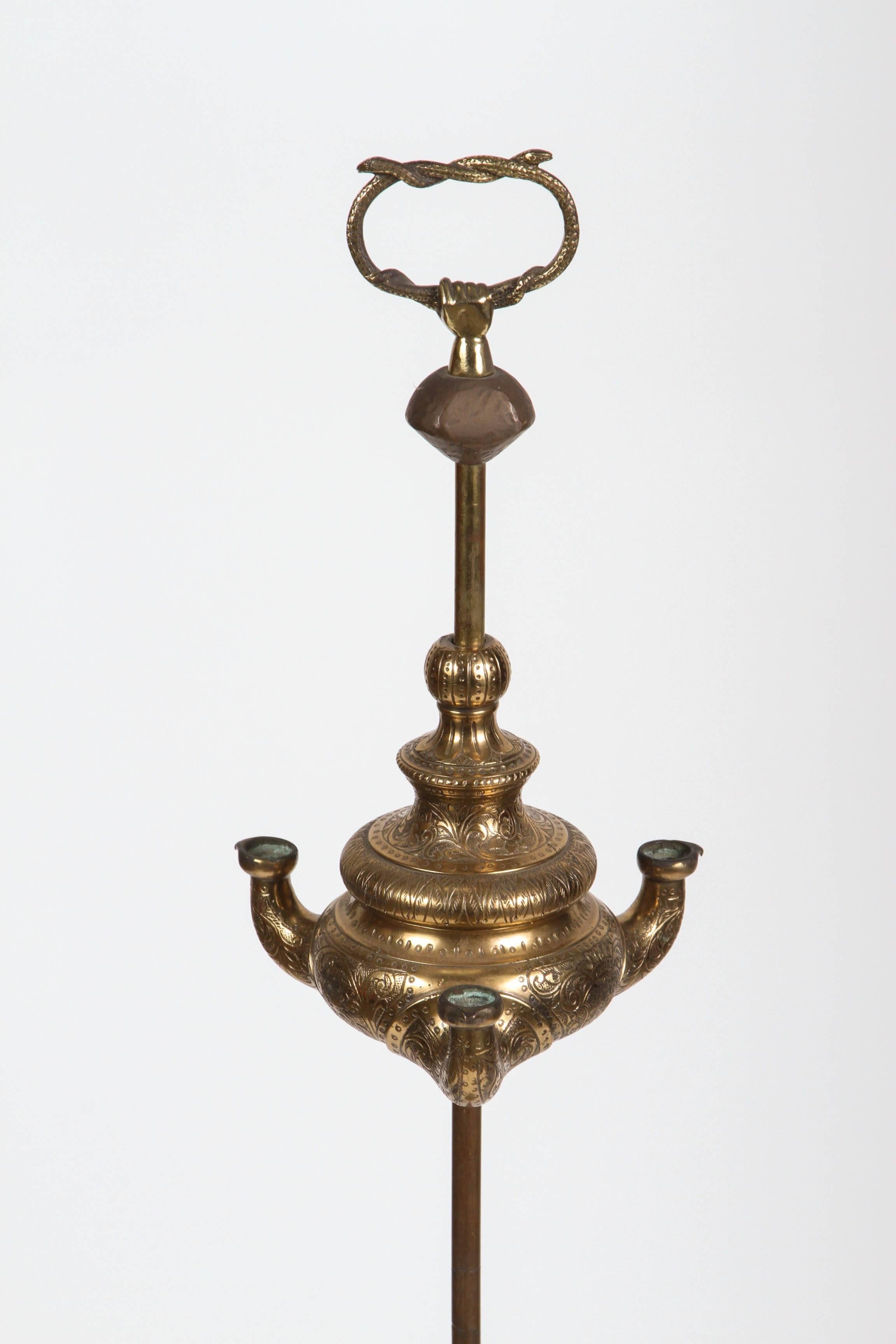 Anglo Raj antique 19th century bronze Indian temple oil lamp.
Whale oil lamp with 4 wick burners.
Fantastic patina and great scale.
Used for sacred ceremonies in temples.
The top show a hand holding 2 snakes.
The brass base is heavily carved with