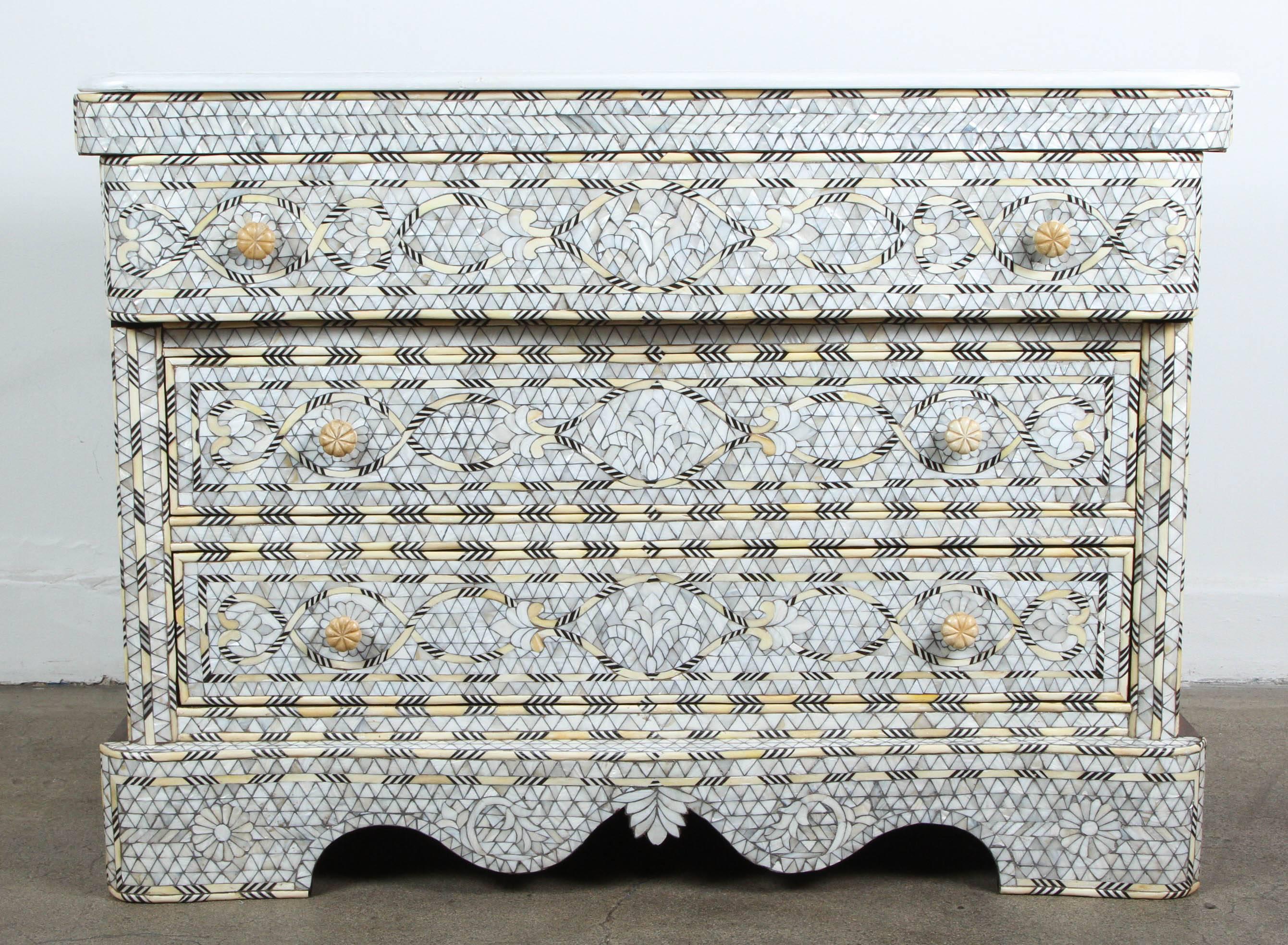 Fabulous pair of Middle Eastern Syrian artwork, handcrafted white wedding dresser with three drawers, wood inlay with mother-of-pearl, shell, ebony and bone.
Moorish arches and intricate Islamic designs.
Dowry chest of drawers heavily inlaid in