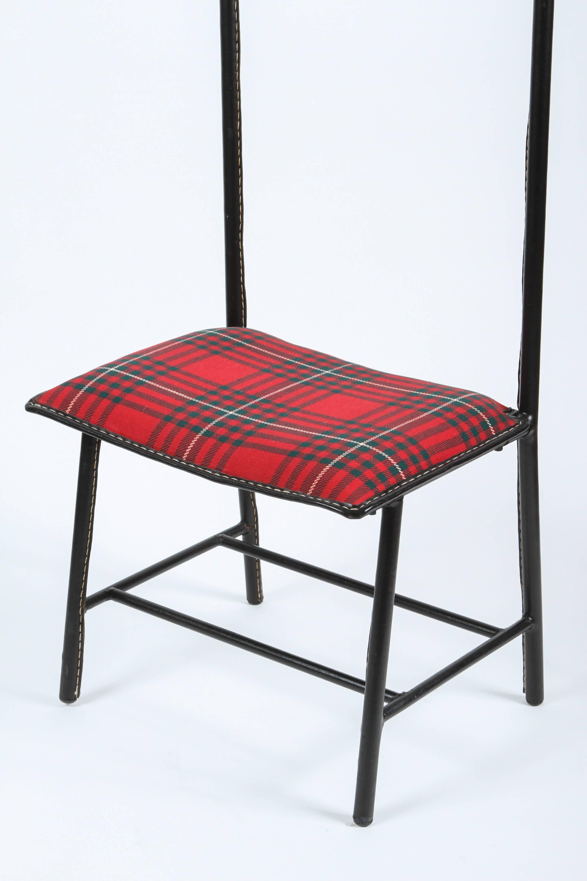 Rare and handsome Jacques Adnet valet de nuit  and seat with leather wrapped hand-stitched in Hermes saddle style and original tartan plaid wool upholstery.
Jacques Adnet valet de nuit by La Compagnie des Arts,
Circa 1960 France.
Iron frame wrapped