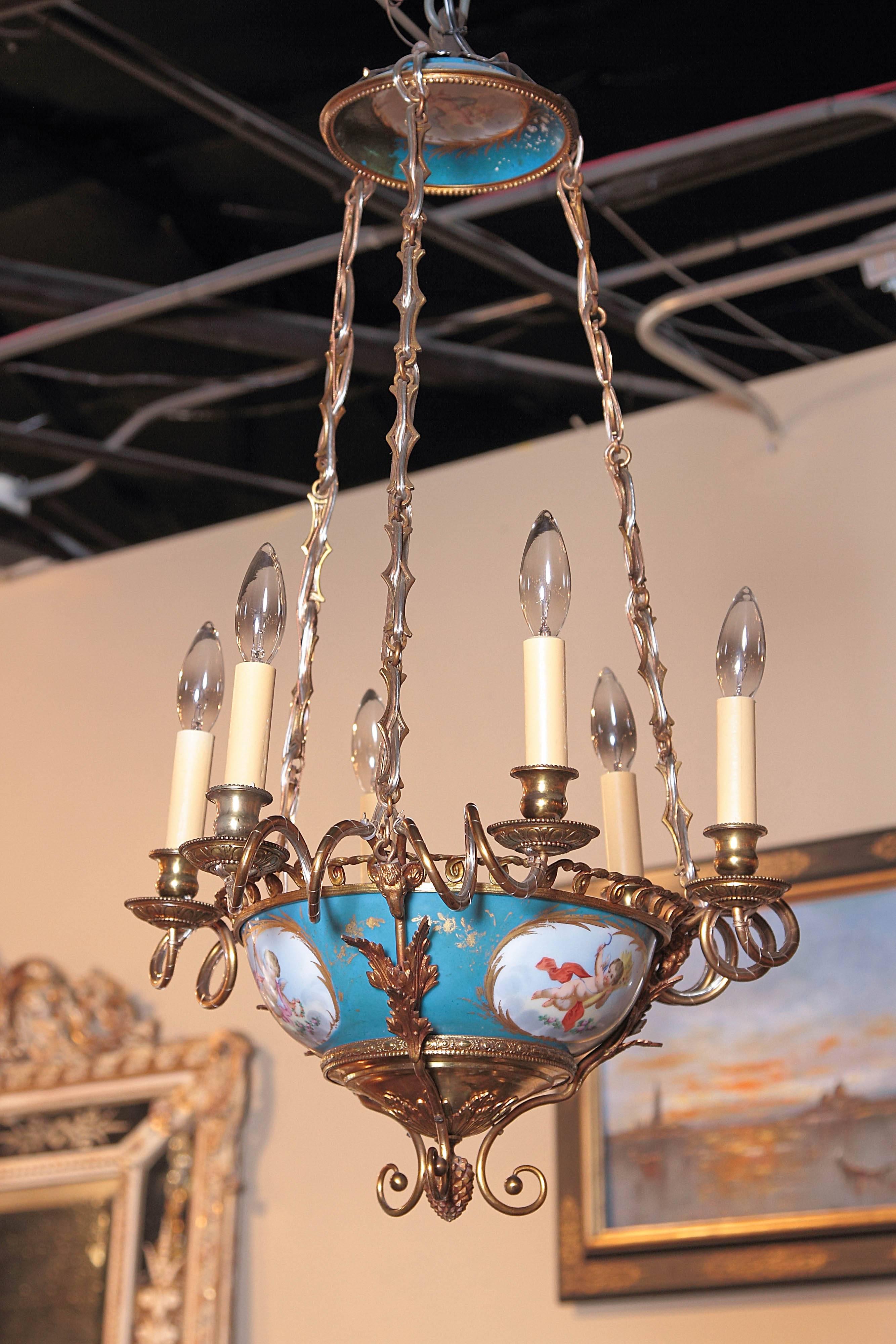 Invite Classic French elegance into your home with this antique chandelier from Sevres, France, circa 1860. The unique chandelier features a bowl-shaped porcelain base with ormolu embellishments. The chandelier has four hand painted cherub
