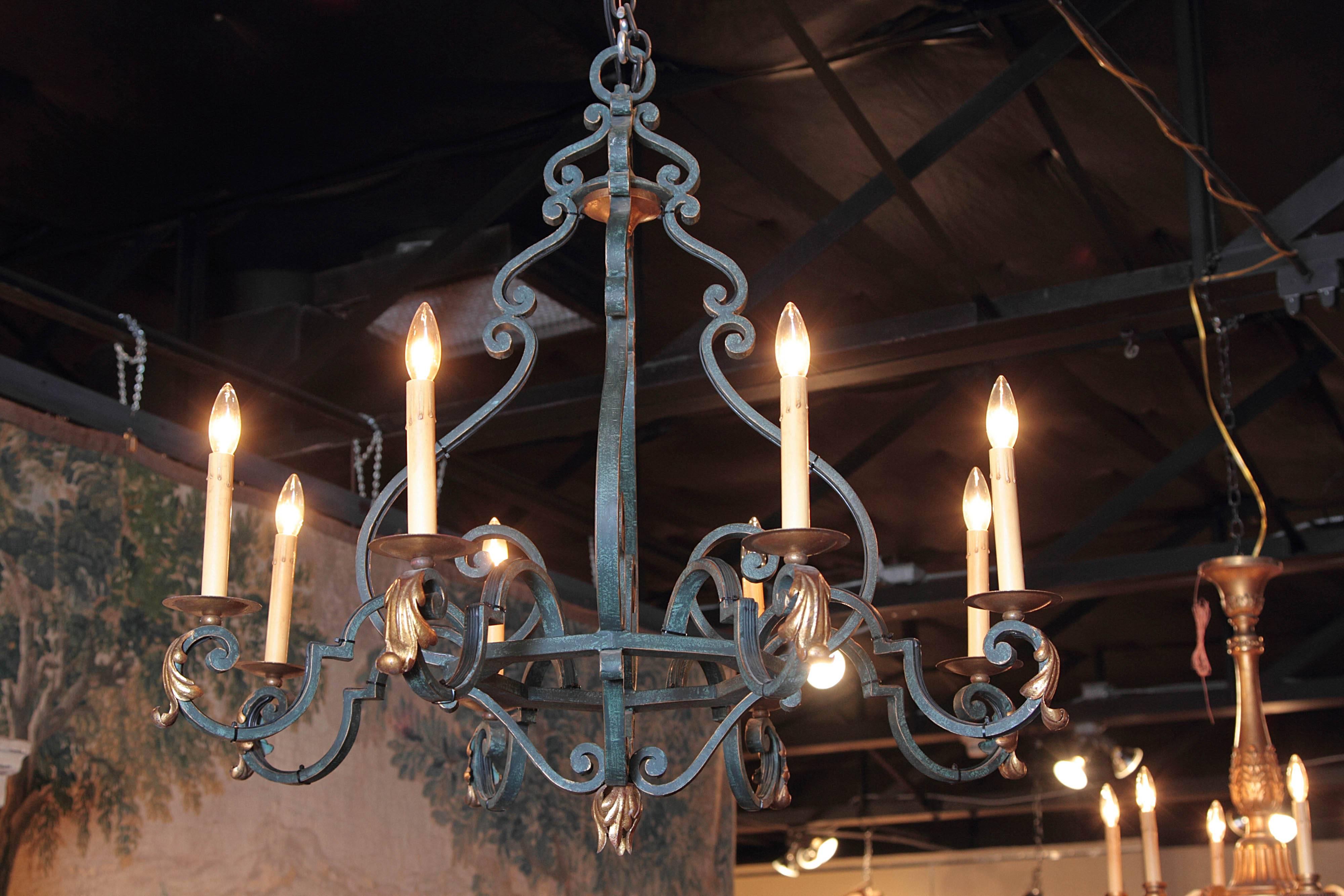 ad French touch to your breakfast room ceiling with his elegant wrought iron chandelier; crafted in France, circa 1940, the fixture has a slim profile that creates an antique, yet surprisingly contemporary look. The scrolling base features eight