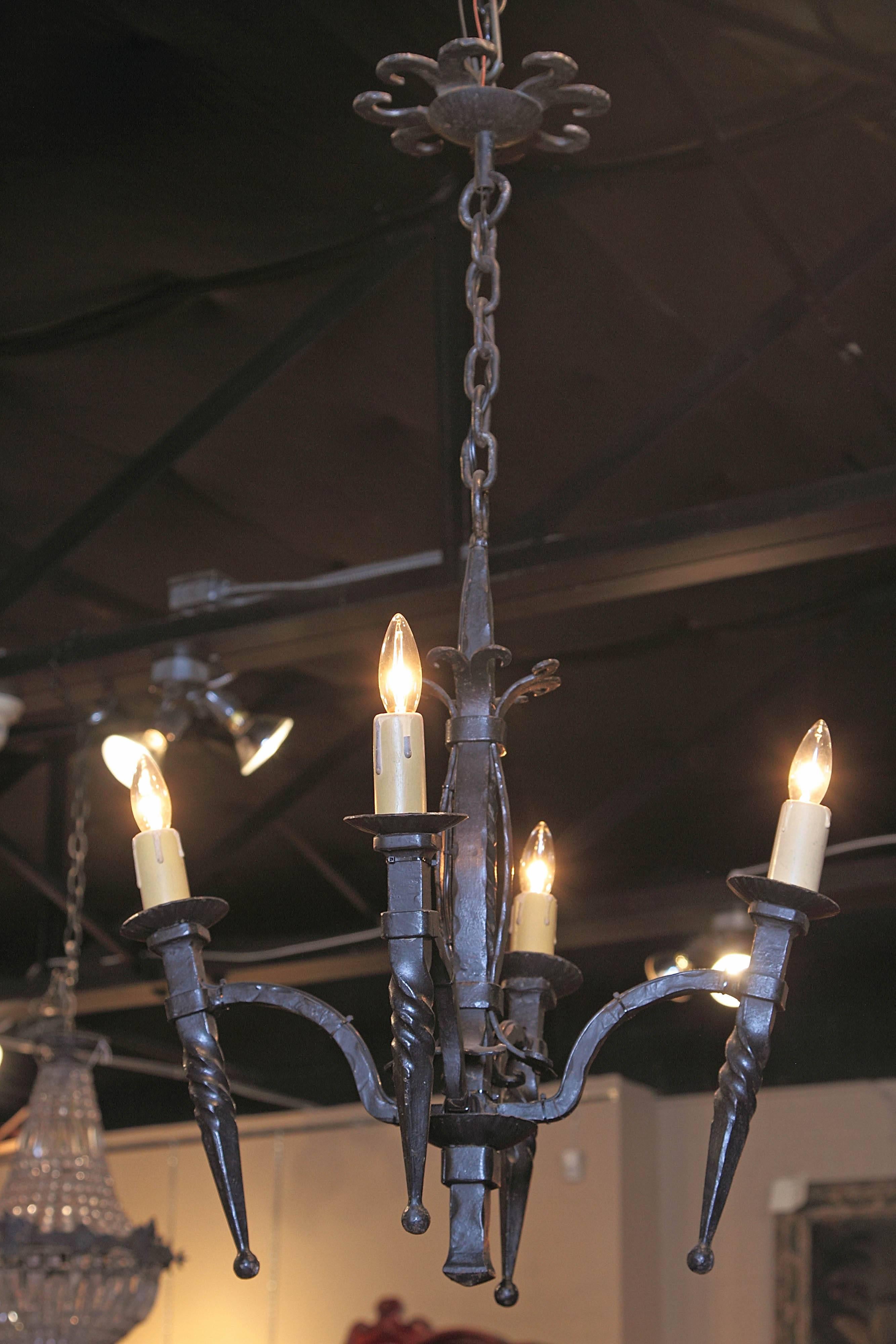 For a simple light fixture that's perfect for a powder room or entryway, look no further than this interesting small antique fixture from Southern France, circa 1880. The simple chandelier has four arms with twisted, torch-like bases. Excellent