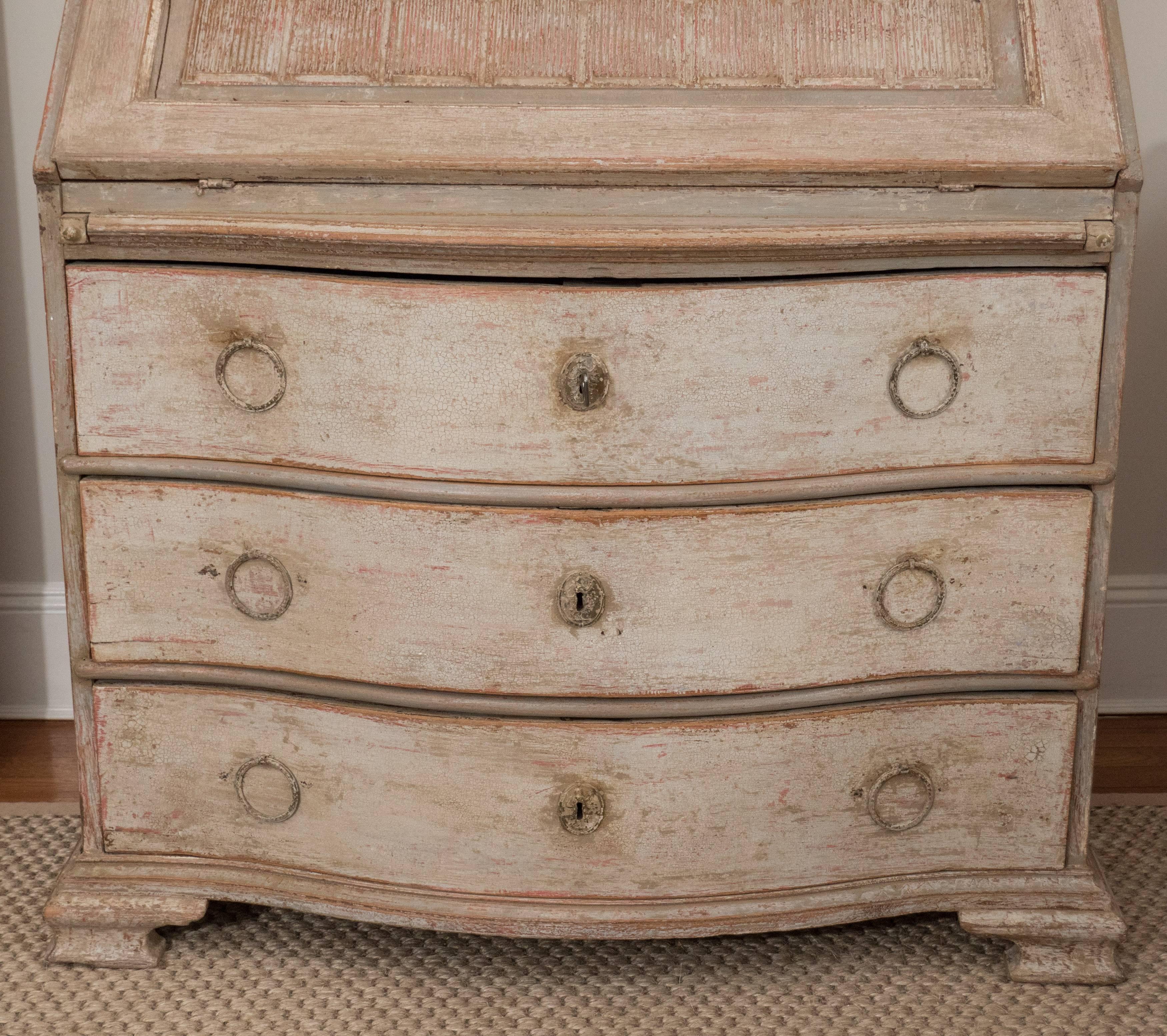 One can design a room around this spectacular piece. Painted in a lovely gray with terra cotta colored interior, this secretary is not only beautiful, but it is quite practical as well. The top features an arched cornice with dentil molding
