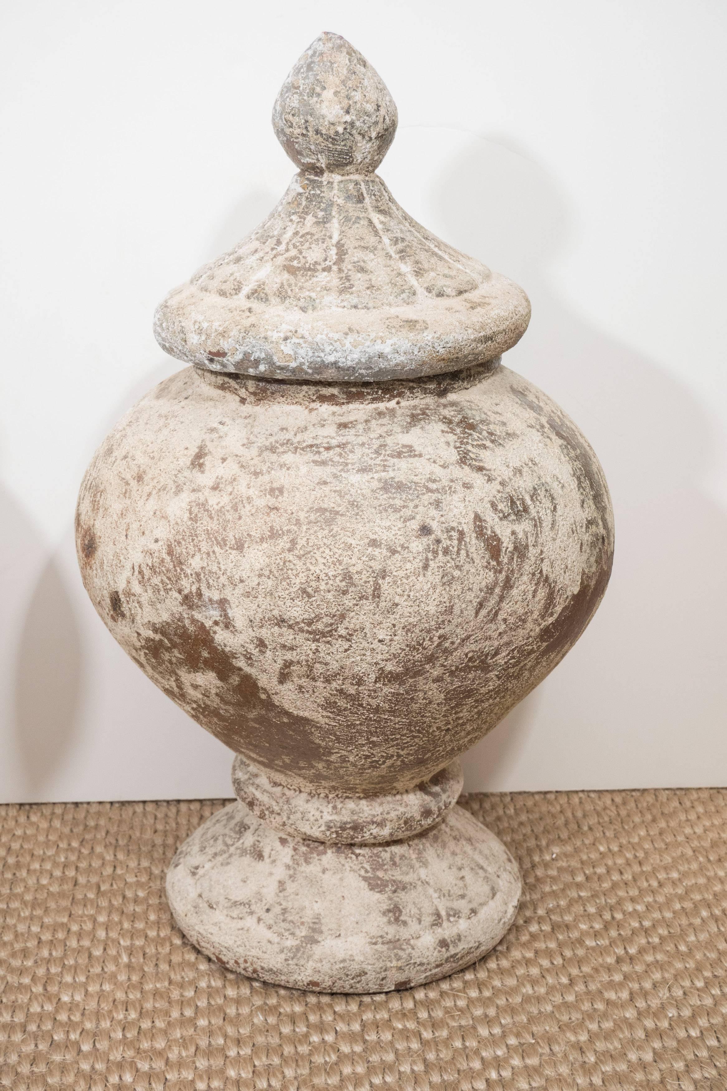 These cement urns with lids have so much character. We love blending rustic and refined. These can go in the garden or among fine antiques.