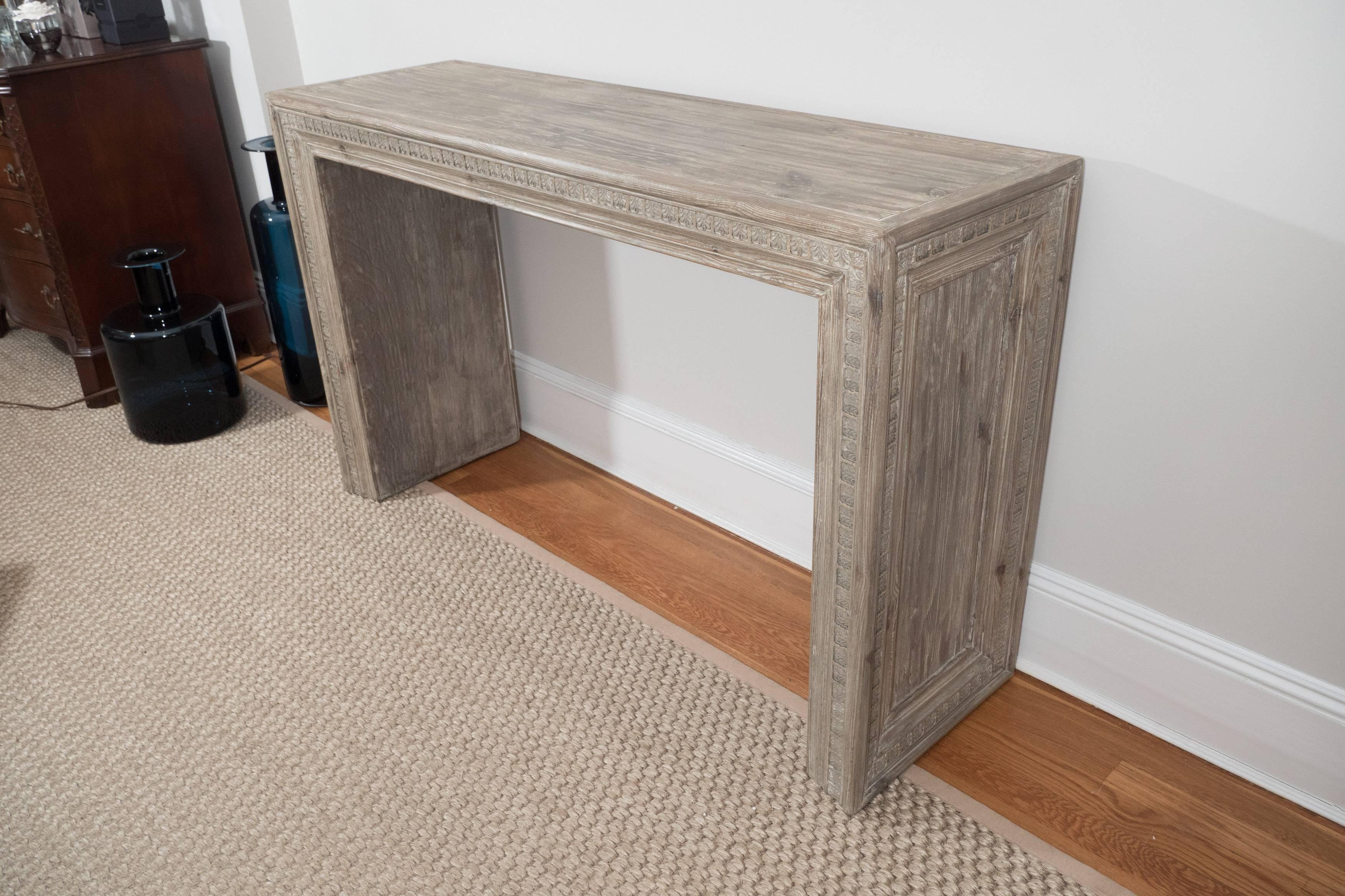 A nice looking console table in a limed oak finish with lovely carved detail on sides and front. Its clean lines allow this piece to blend well in modern as well as traditional interiors.