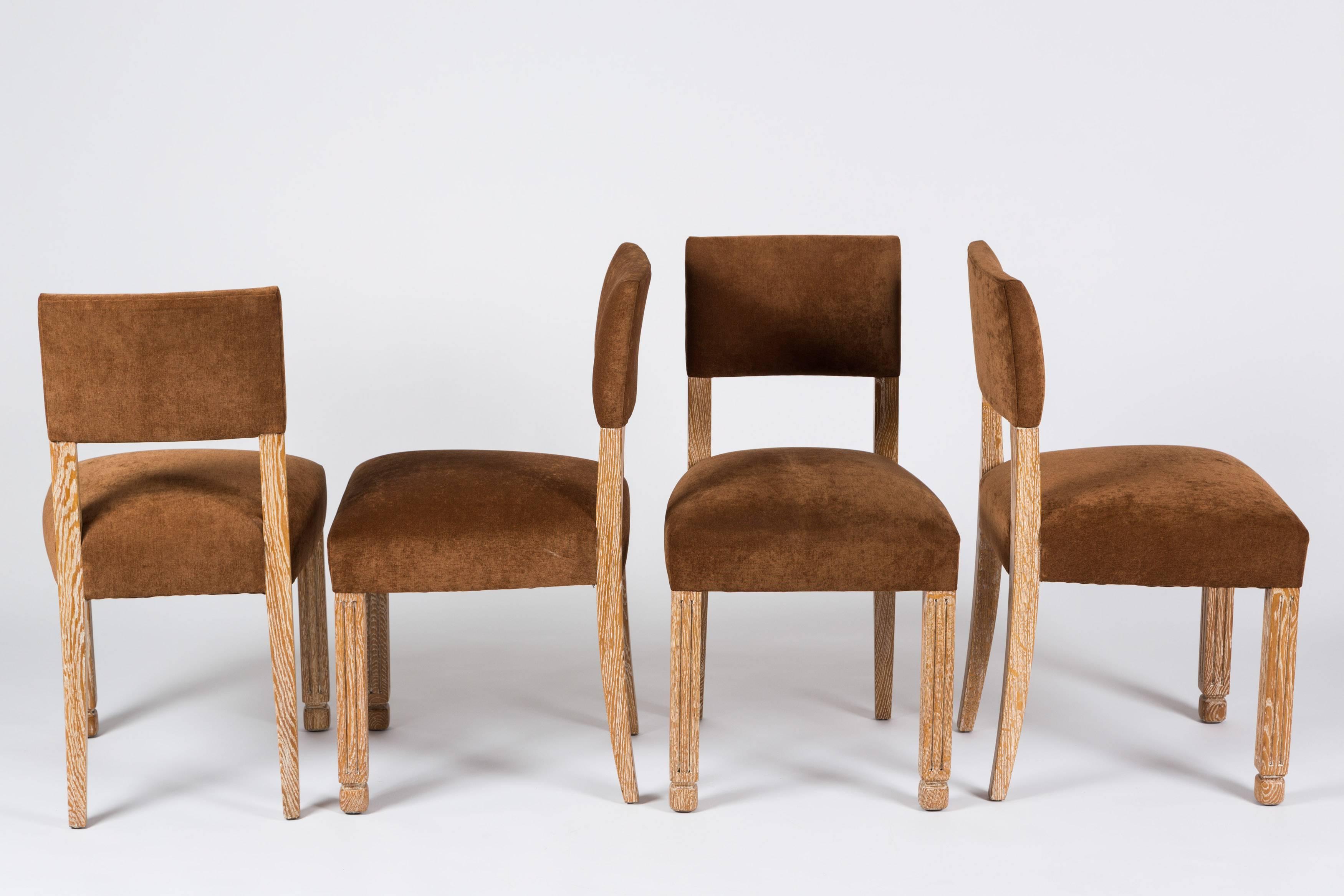Set of four Mid-Century French limed oak chairs upholstered in caramel-colored velvet.