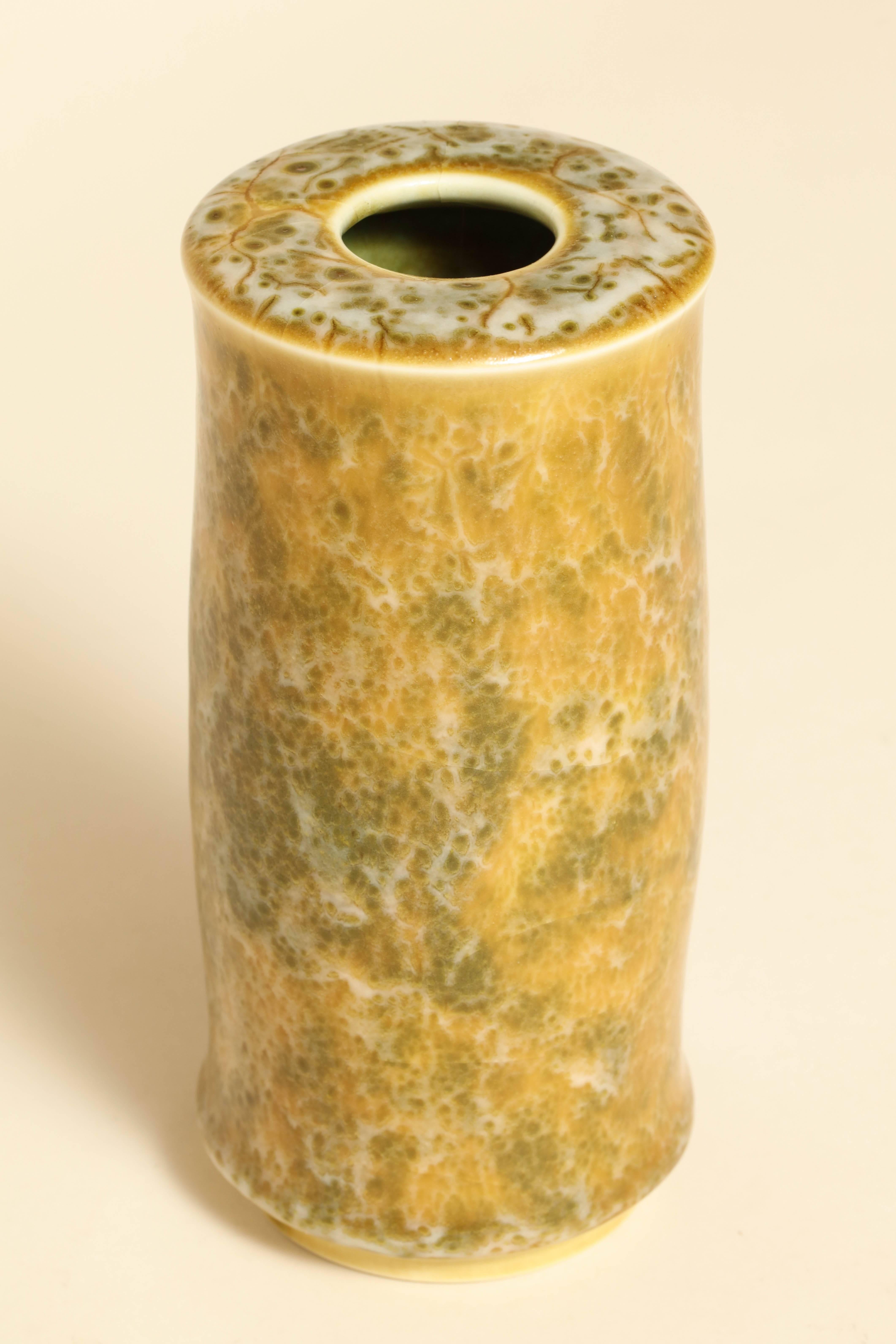 Stoneware cylindrical vase with projections and with mottled yellow ochre, green and white glaze.
Signature incised Maurice Gensoli underneath.
 