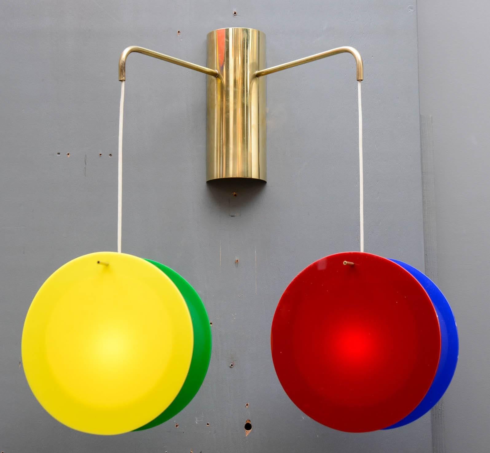 Great pair of wall sconces made of brass structures from where hangs two sconces made of three colored panels of plexiglass.

Each piece is signed and numbered.