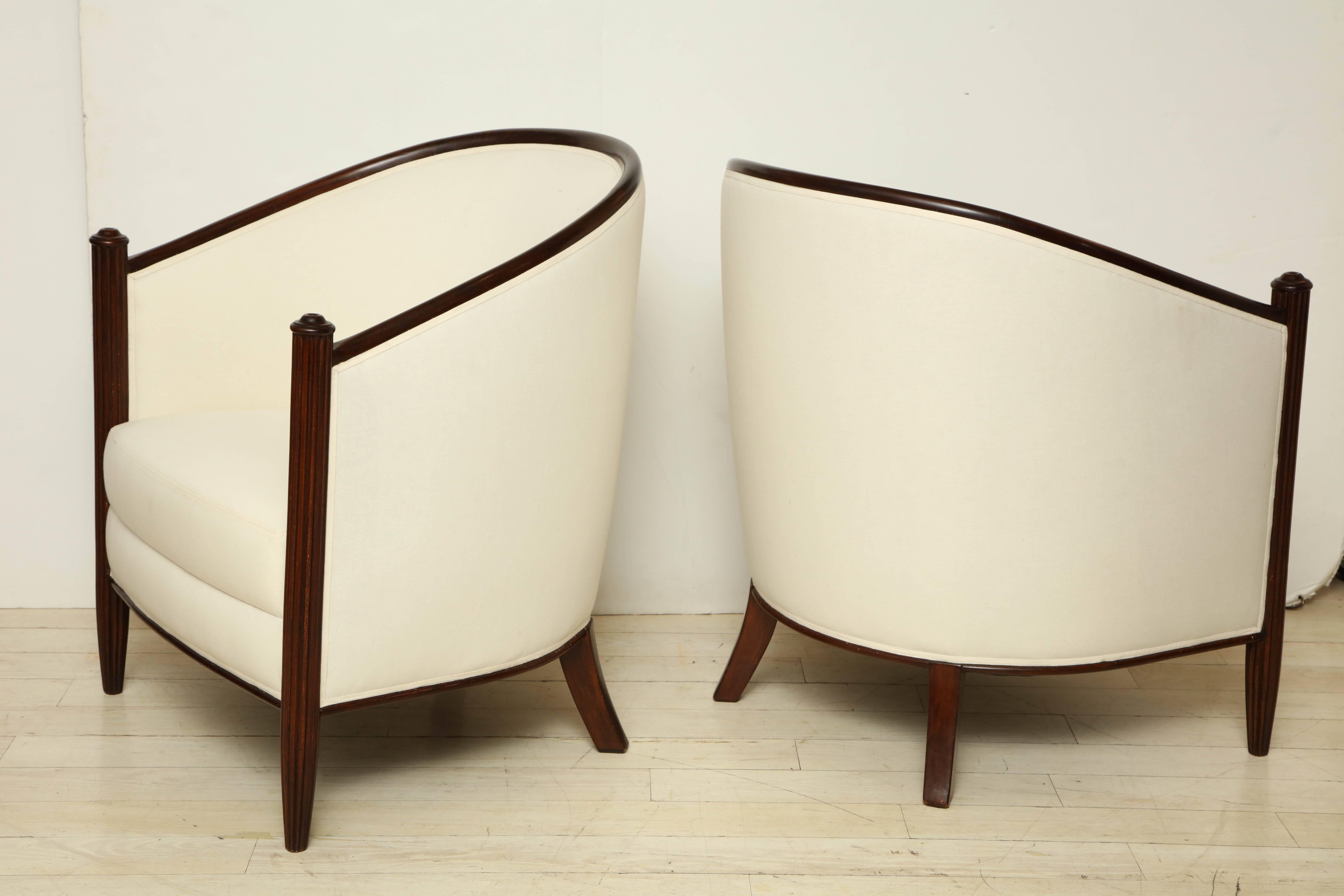 Pair of French Art Deco rounded back beech armchairs with reeded front supports. Newly upholstered in white muslin.
