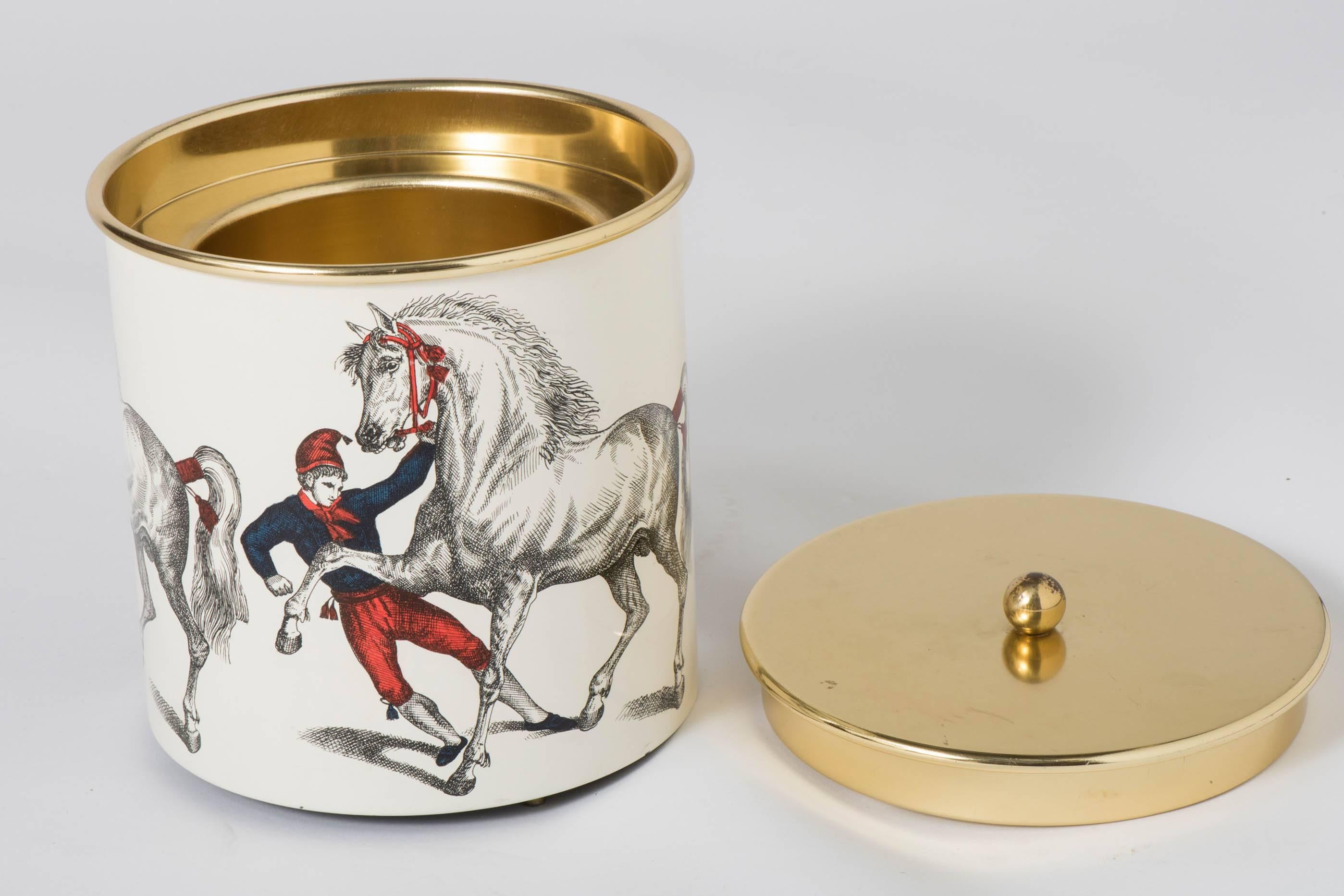 An early ice bucket by Piero Fornasetti.
“Cavalli Ramanti”
Rearing horse.
Lithographically printed and hand colored,
Metal and brass.
Italy, circa 1960.
  