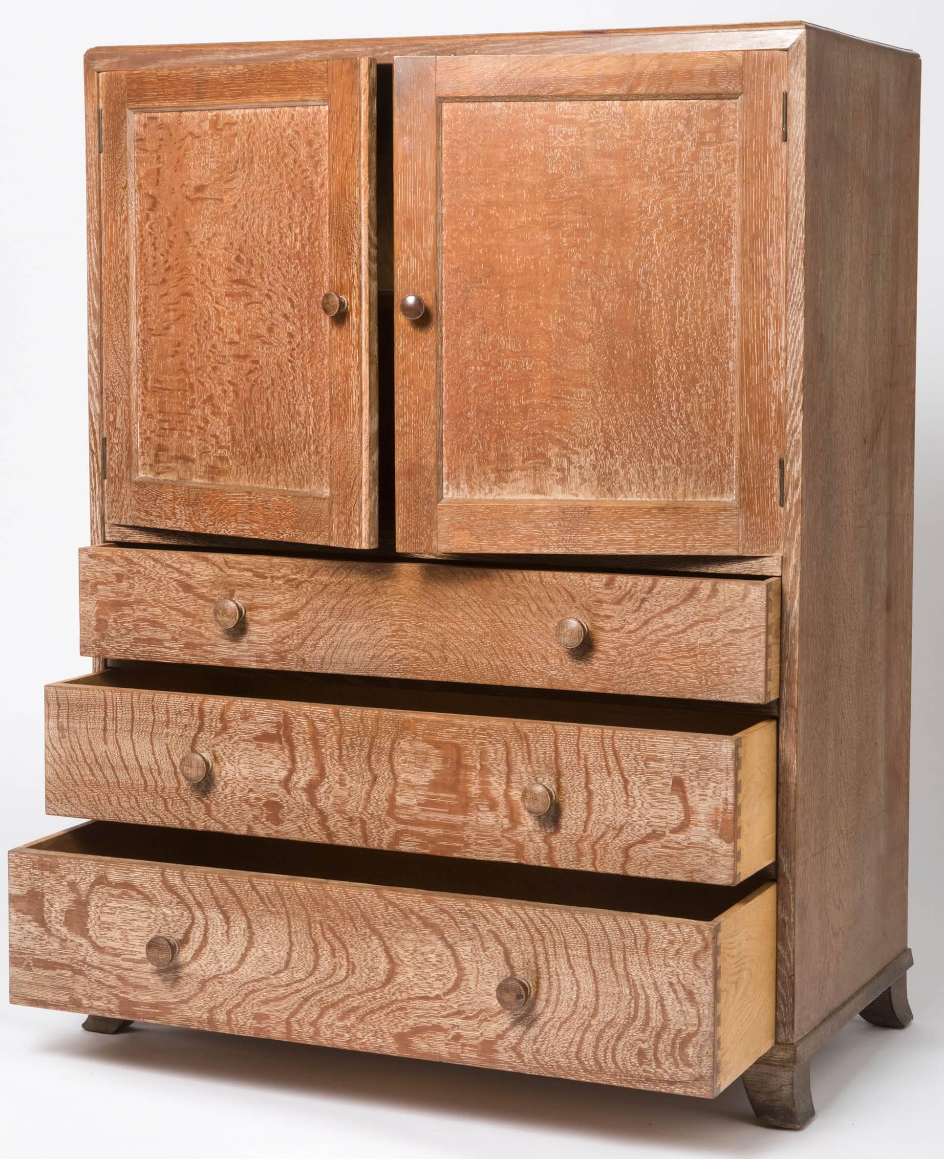 A limed oak tallboy by heals of London.
Twin cupboard doors above three long graduating drawers.
Swept bracket feet.
England, circa 1920
Measures: 122 cm high x 91 cm wide x 47 cm deep.
  