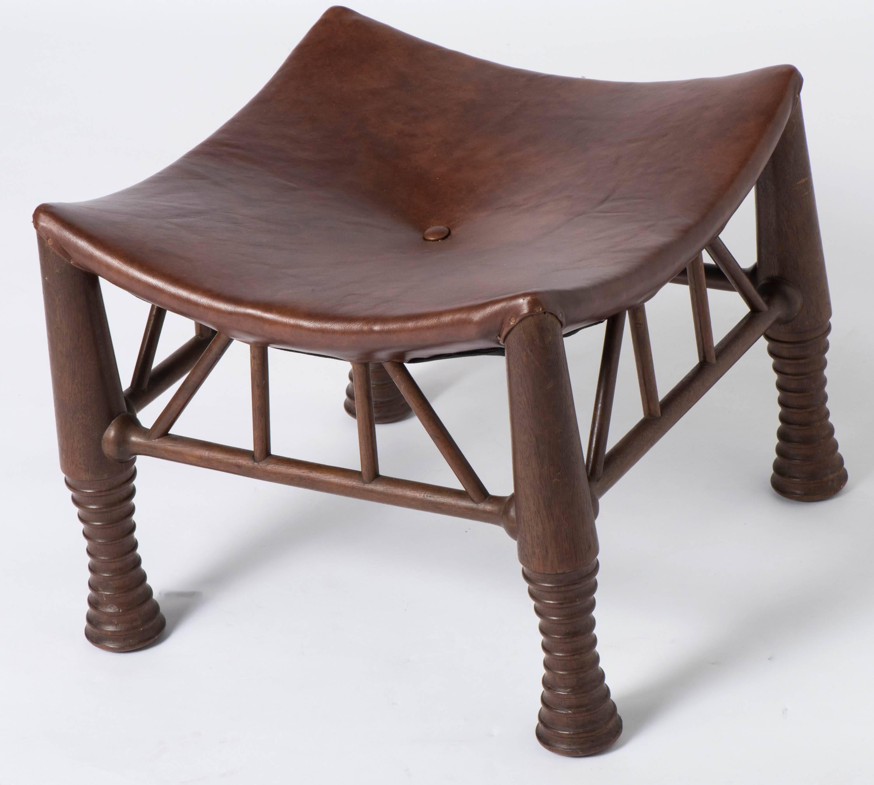 A large mahogany Thebes Stool by Liberty and Co, London.
With leather upholstered dished seat. Raised on ring turned supports linked by stretchers.
England, circa 1900
Measures: 44 cm wide x 44 cm deep x 37 cm high.