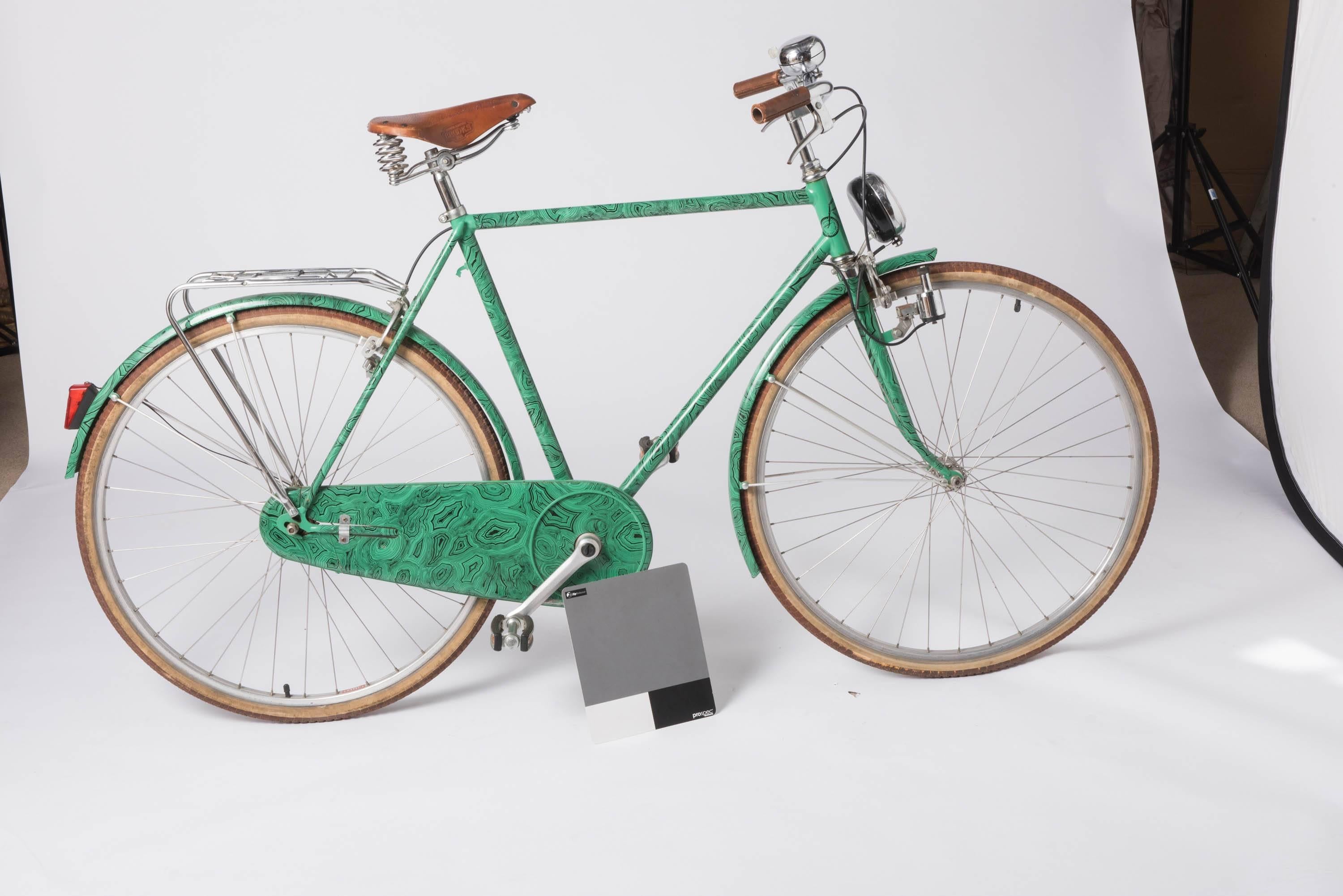 A very rare bicycle by Piero Fornasetti.
“Malachite”
Metal lithographically printed and hand coloured.
Frame tubing without visible joints.
Pedals without bolts on the pants protector plates
Handle bar grips and chair guard cover in hand-stitched