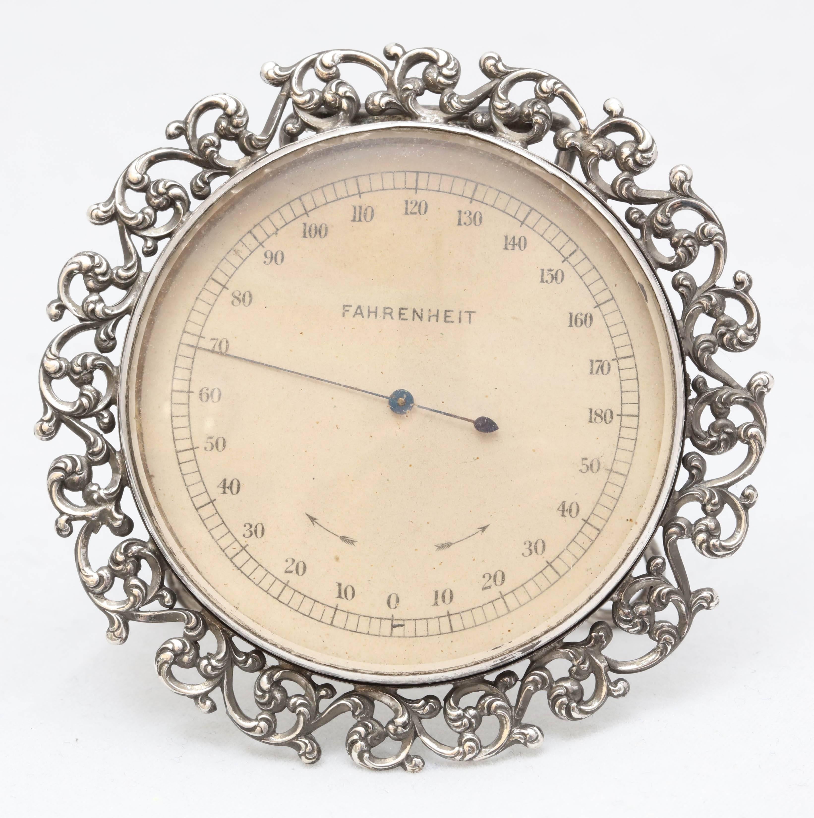 Victorian, sterling silver table thermometer, American, circa 1895. Beautiful pierced work on border. Measures: 2 12 inches diameter. Sterling silver is in excellent condition and thermometer is in excellent working condition.